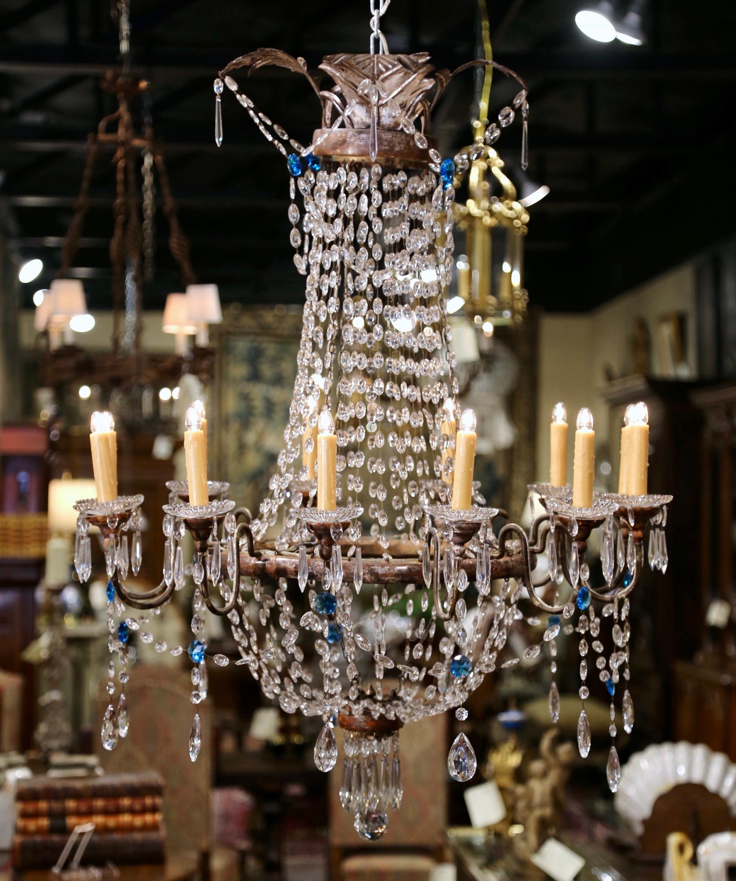 For a luxurious statement, hang this grand antique Genovese chandelier in a living room or a dining room; crafted in Italy, circa 1880, the elegant light fixture has a central carved stem with silvered leaf finish embellished at the top with