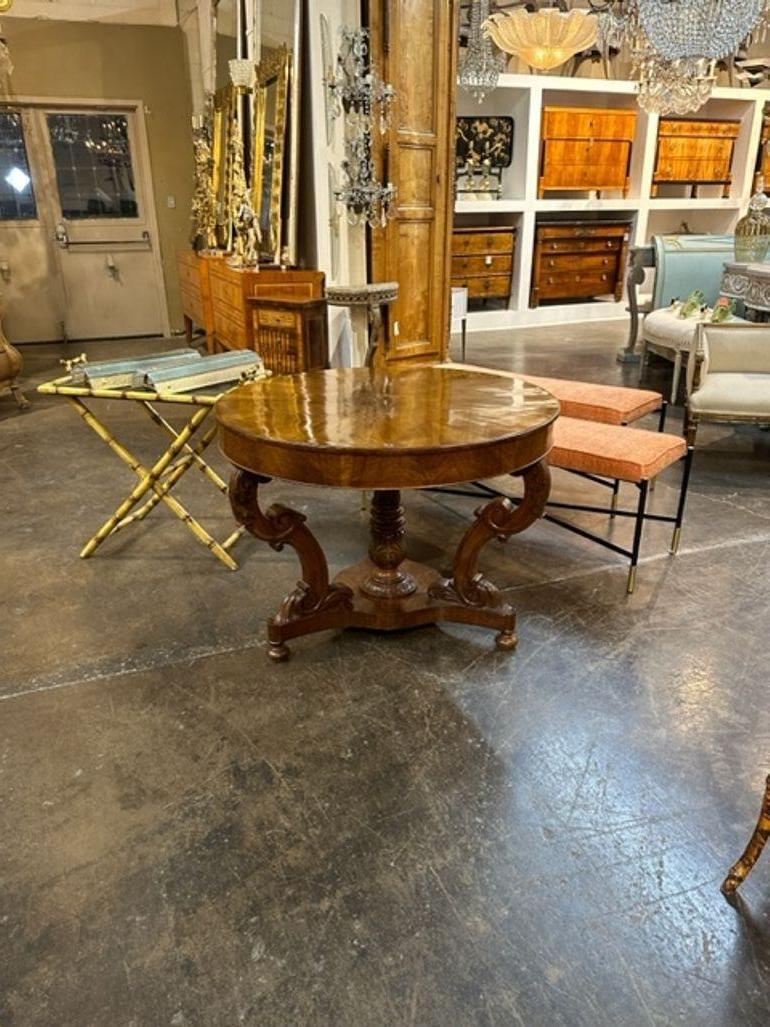 Handsome 19th century Italian carved walnut center table. Featuring a beautiful, polished finish and a lovely carved based. So elegant!