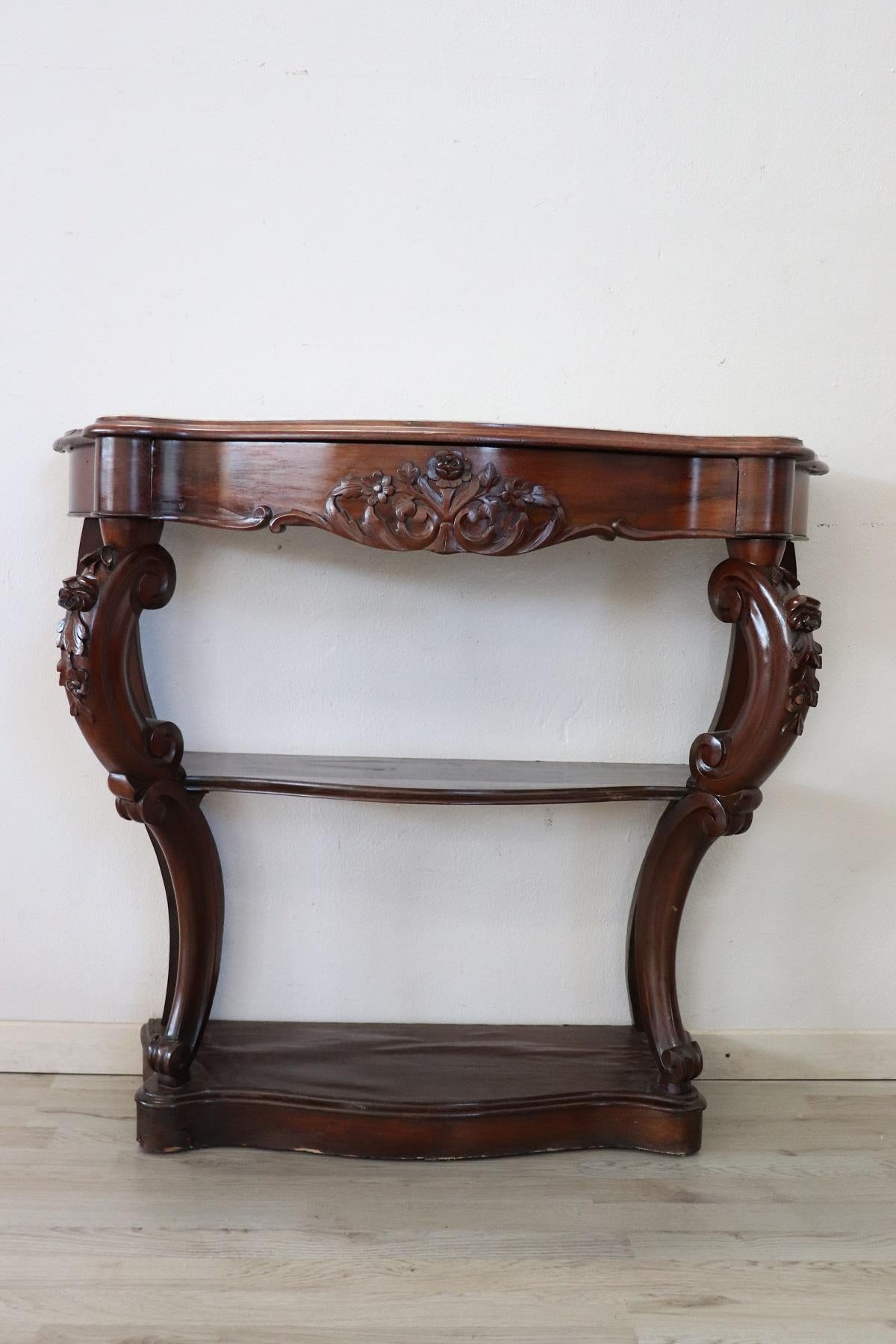 Antique console table of rare small size mid-19th century in full Louis Philippe era. The console is made of solid carved walnut with floral decorations, on the front a comfortable drawer. Rare due to its small size, perfect to be placed even in