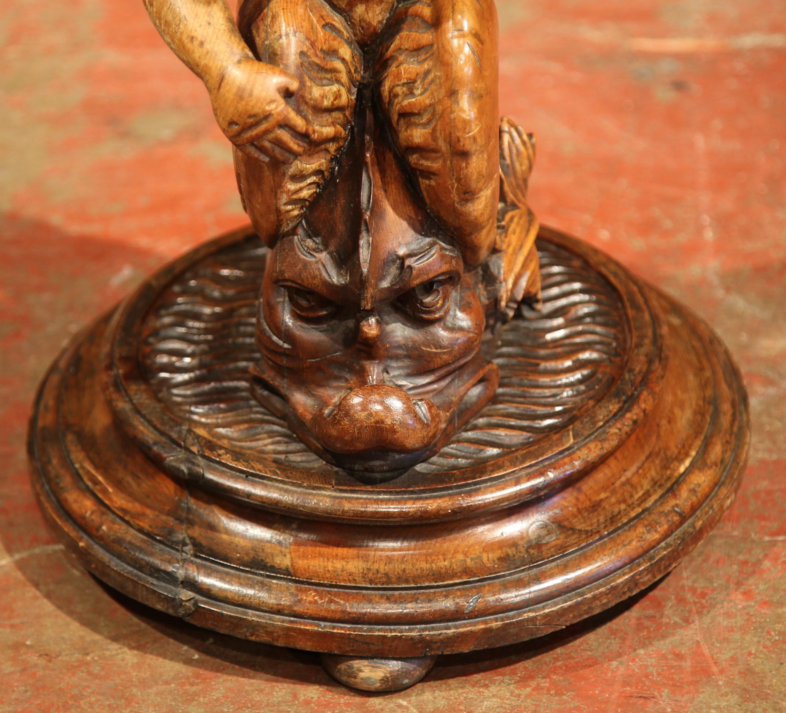 Patinated 19th Century Italian Carved Walnut Pedestal Table with Cherub Figure