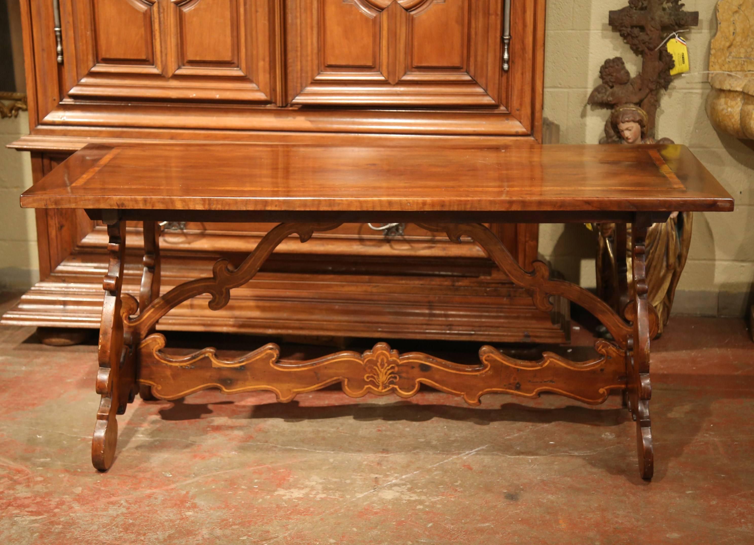 Patinated 19th Century Italian Carved Walnut Trestle Table with Decorative Inlay Motifs