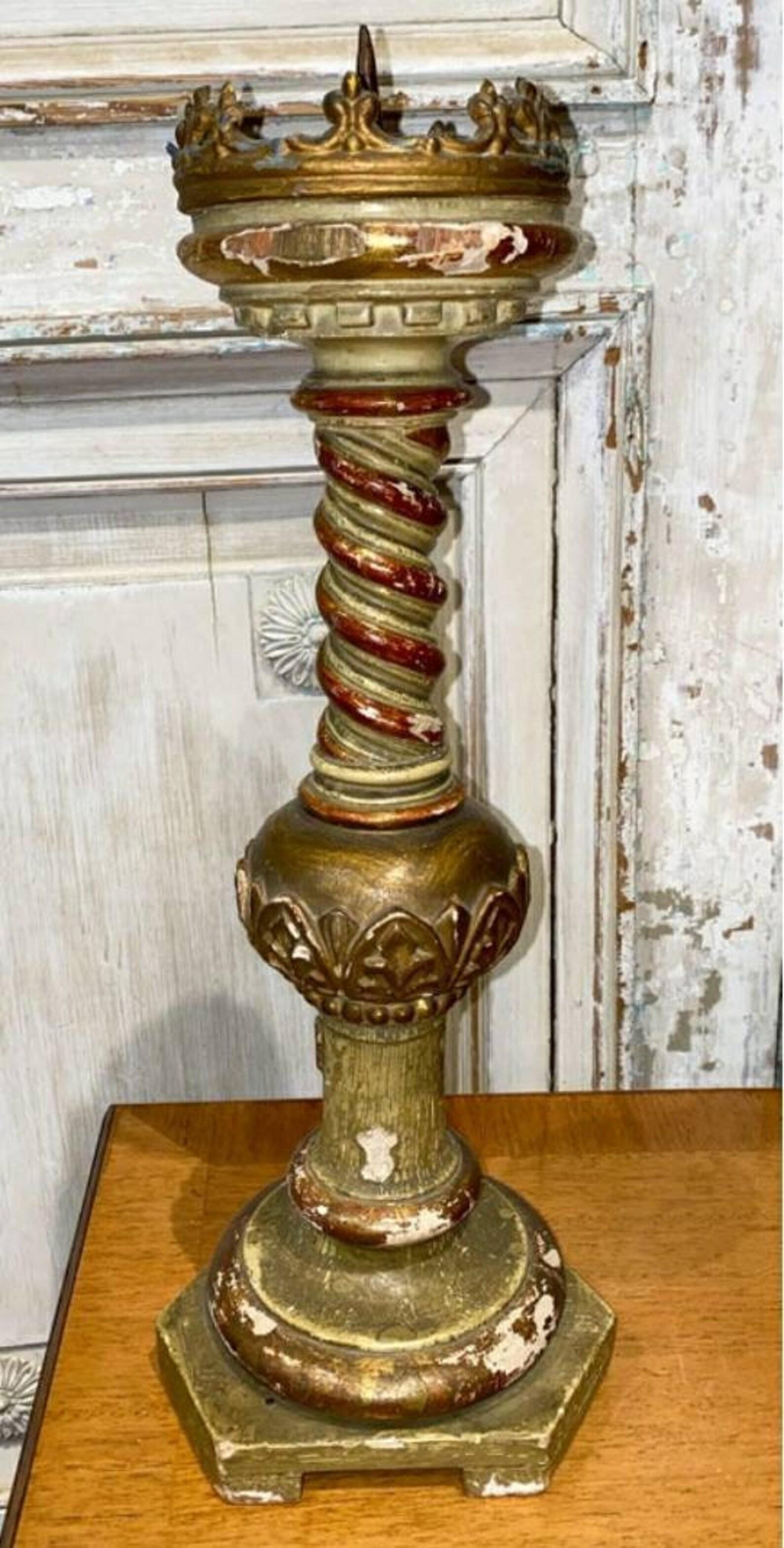 A scarce Italian hand carved polychromed parcel gilt church altar stick.  Born in Italy in the second half of the 19th century, having a sculptural crown shaped gilt metal top surrounding a tall candlestick pricket, over carved and spiral turned