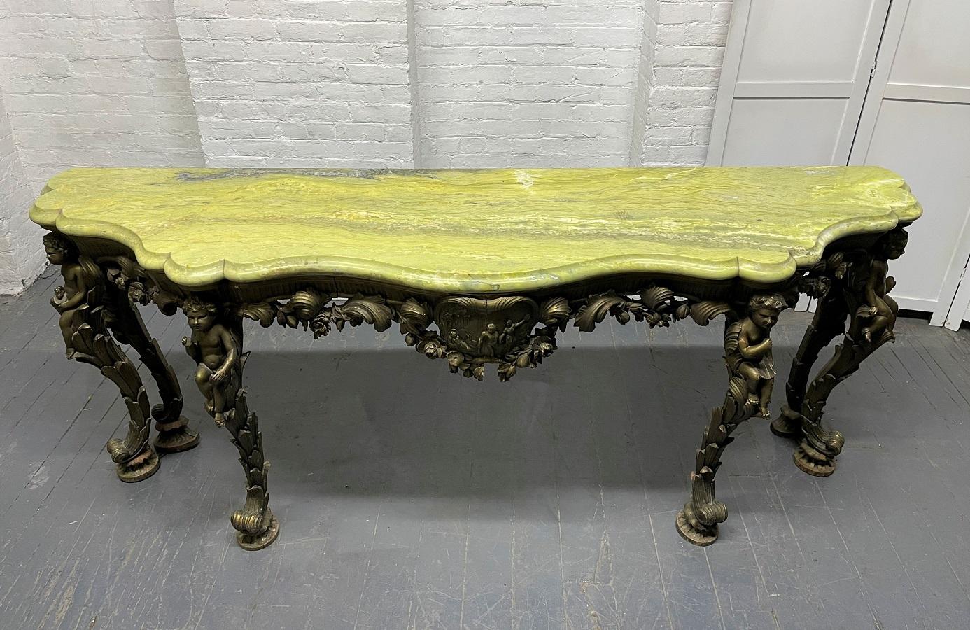 19th century Italian carved wood marble-top console. Has carved Puttis to the front and sides. Marble is green and one inch thick. The console is all carved wood.
