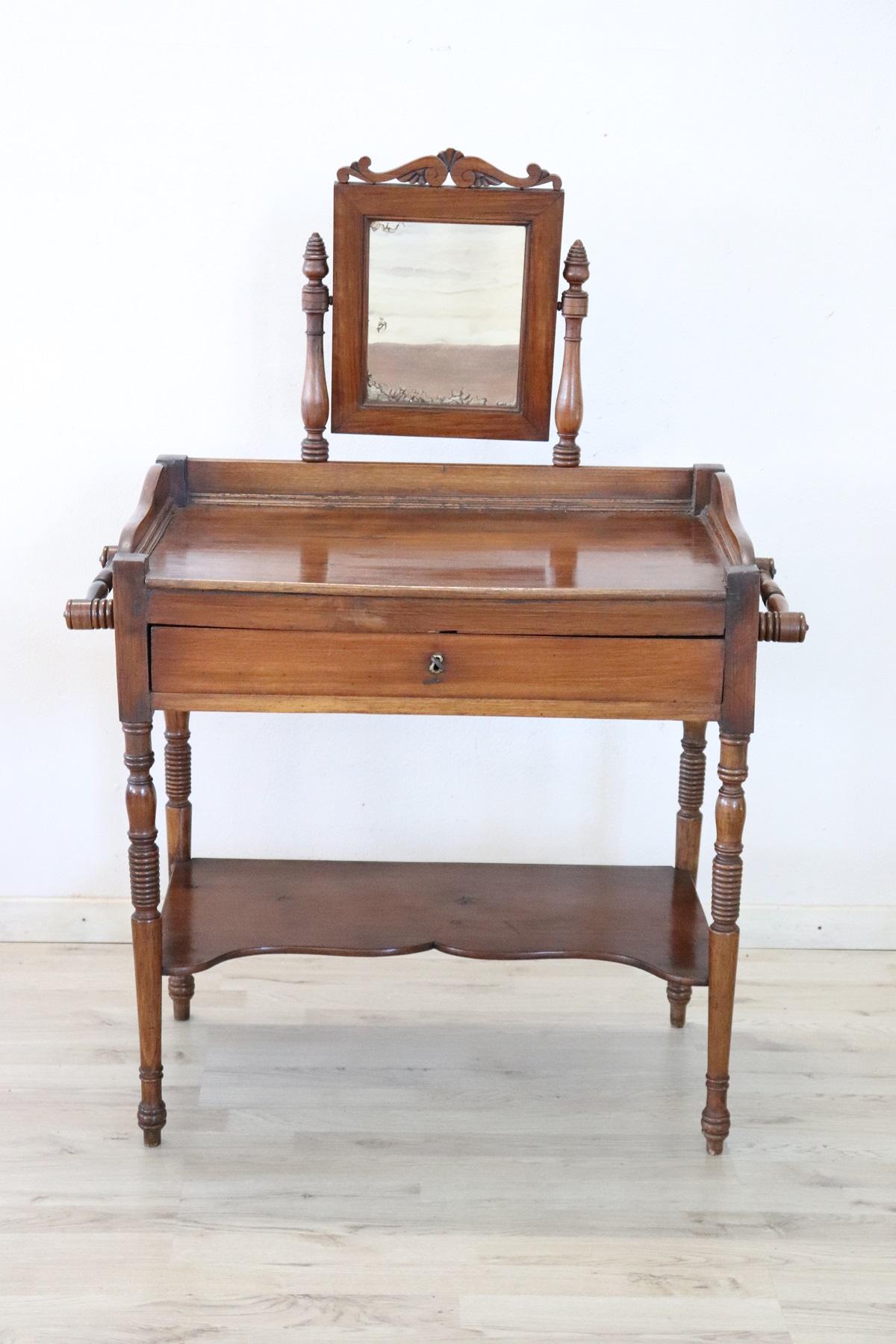 Beautiful particular solid walnut wood Charles X vanity table, 1825. Characterized by small turned legs and useful drawer under the top. Small antique mirror with mercury mirror. Perfect to be used in the bedroom for make-up. This piece of furniture