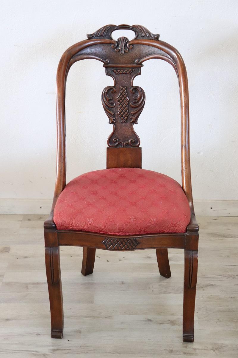 Beautiful 19th century of the period Charles X Italian set of 2 chairs antique in solid walnut wood. Characterized by an enveloping and refined backrest, embellished with an elaborate decoration hand-carved in walnut wood. The seat is wide and