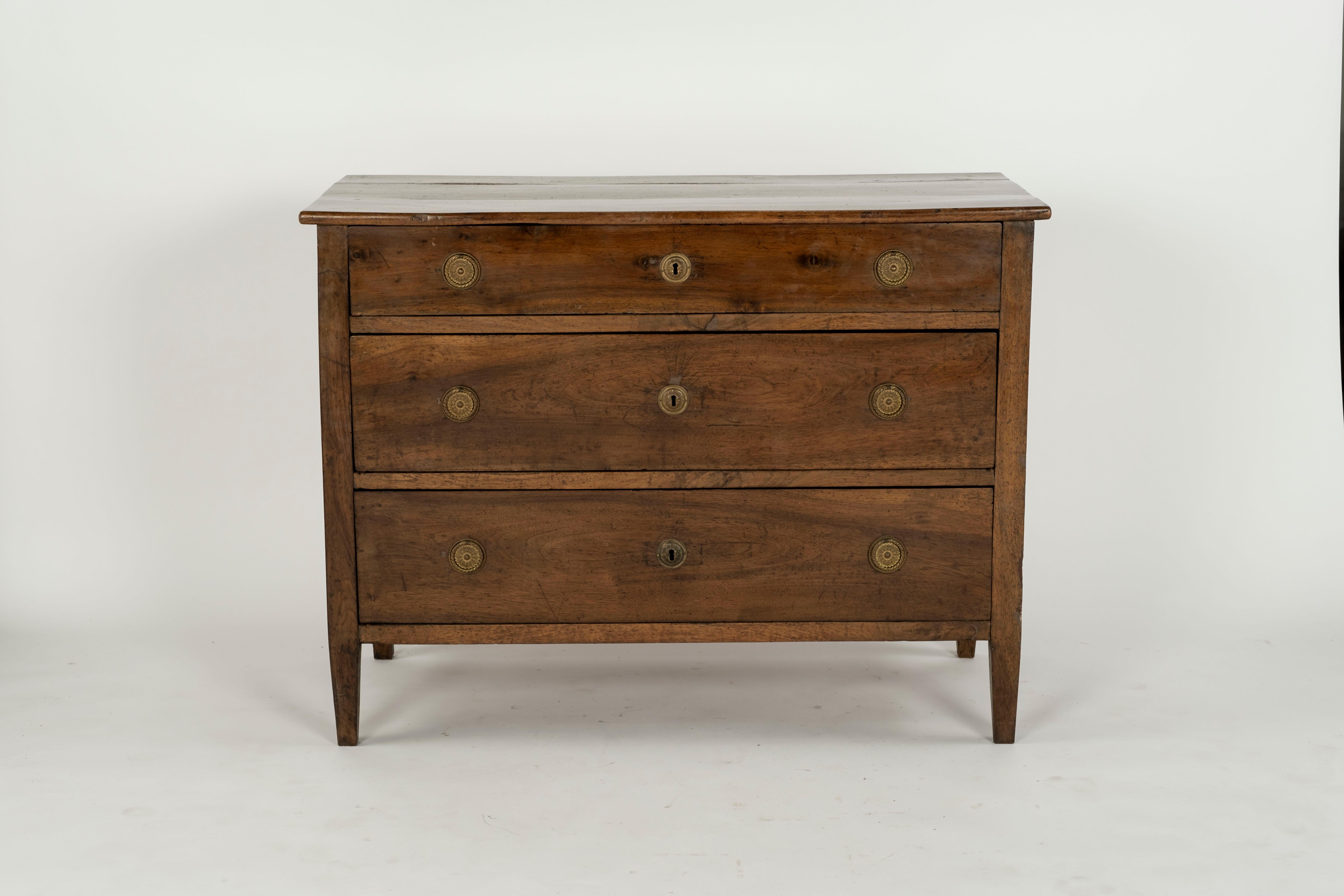 Antique Italian walnut commode, 18th/ 19th c., three drawers with ring pulls, rising on tapered square legs, later hardware.