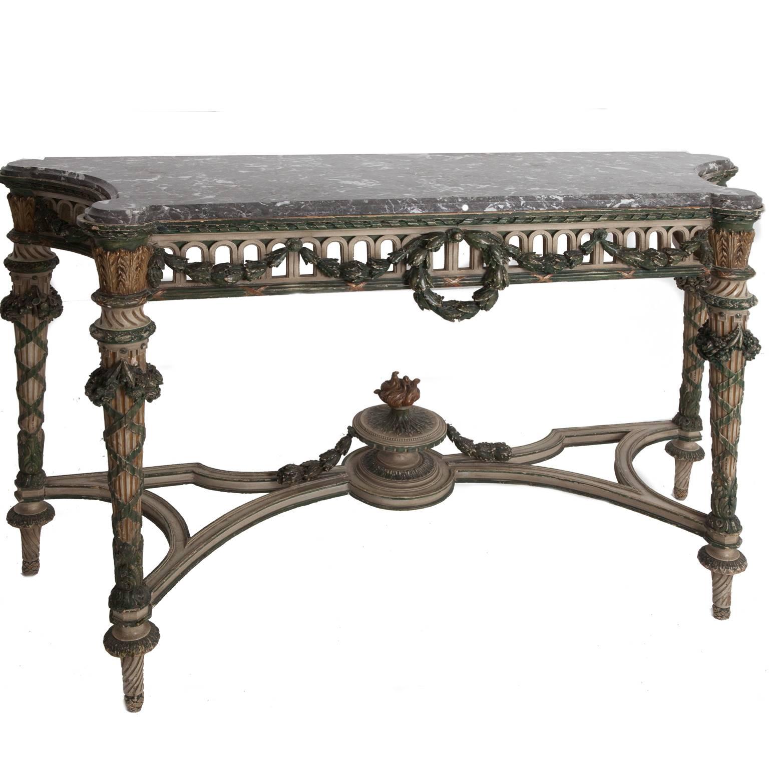 Late 19th century Italian console table. Painted and parcel-gilt with pierced frieze on fluted stretched supports with St Anne’s veined grey marble top. Salvaged from an English manor house.
 