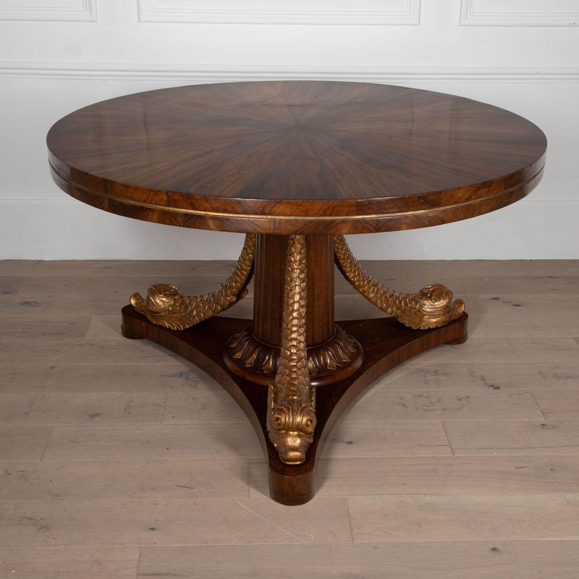 An incredible Italian coromandel centre table on a fluted base.
The top terminates on carved giltwood dolphins.