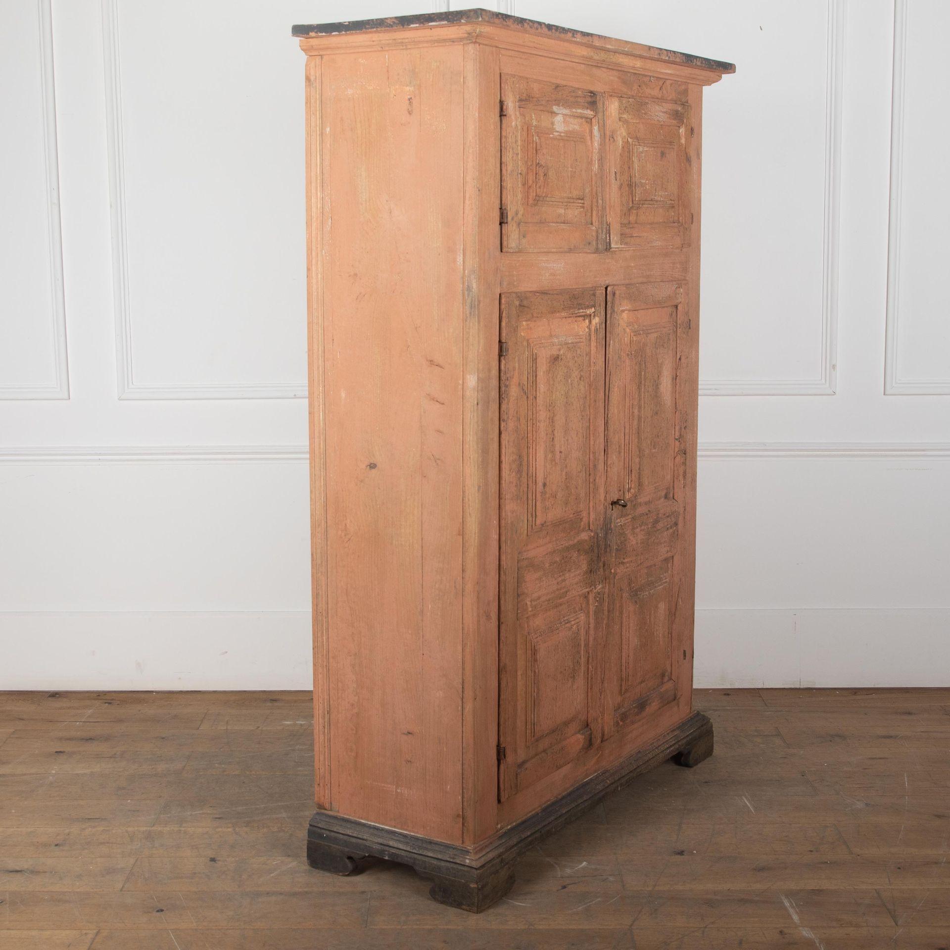 19th Century Italian, useful cupboard with two fielded panelled doors beneath a smaller compartment with two fielded panelled doors.
Retaining the original ochre paint finish. With one key for both locks.
Un-painted interior with three adjustable