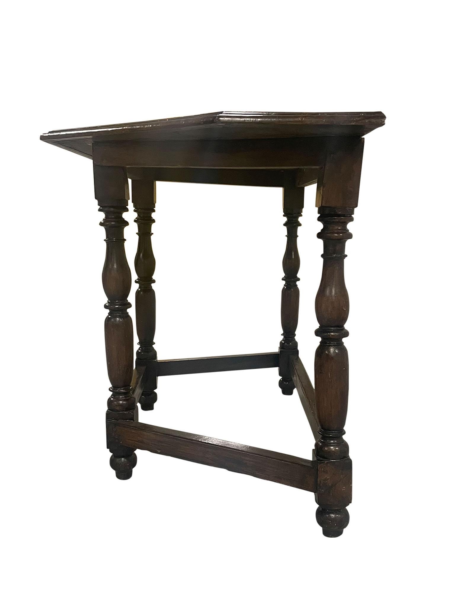 Lovely 19th Century Italian Trapezoid or “D” Shaped Console Table. Crafted in a rich walnut, this table was designed in the Neoclassical style with beautiful turned spindle legs and joined with a sturdy box stretcher. This table is a perfect shape