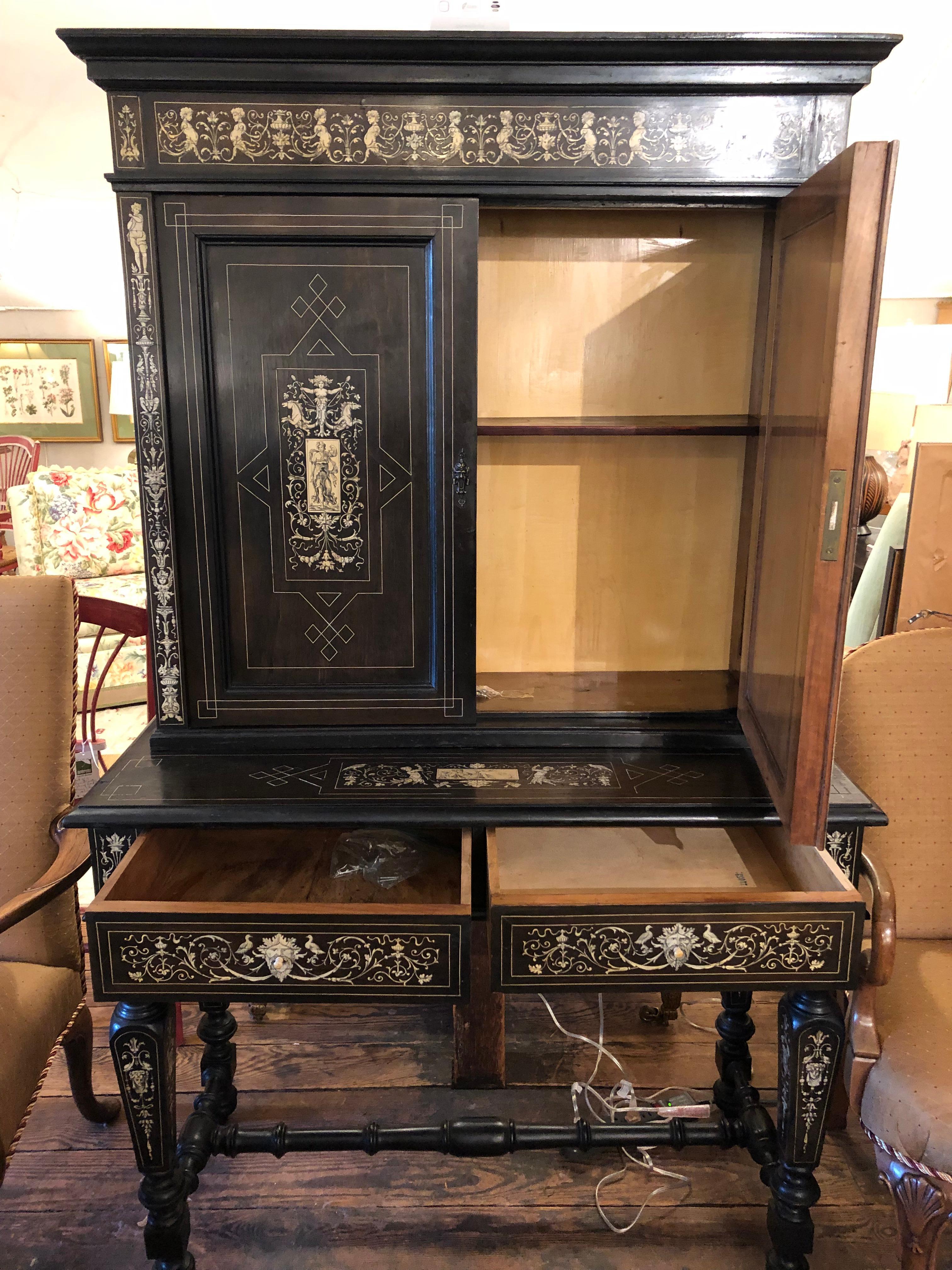 Breathtaking black and white ebonized wood sideboard cabinet having meticulous bone inlay figural decoration.  The Milanese Italian antique cabinet comes in two pieces.   The top (39.75 w at top  11.5 d at top 36.5 w body  9.75 d 36.5 h) has a pair