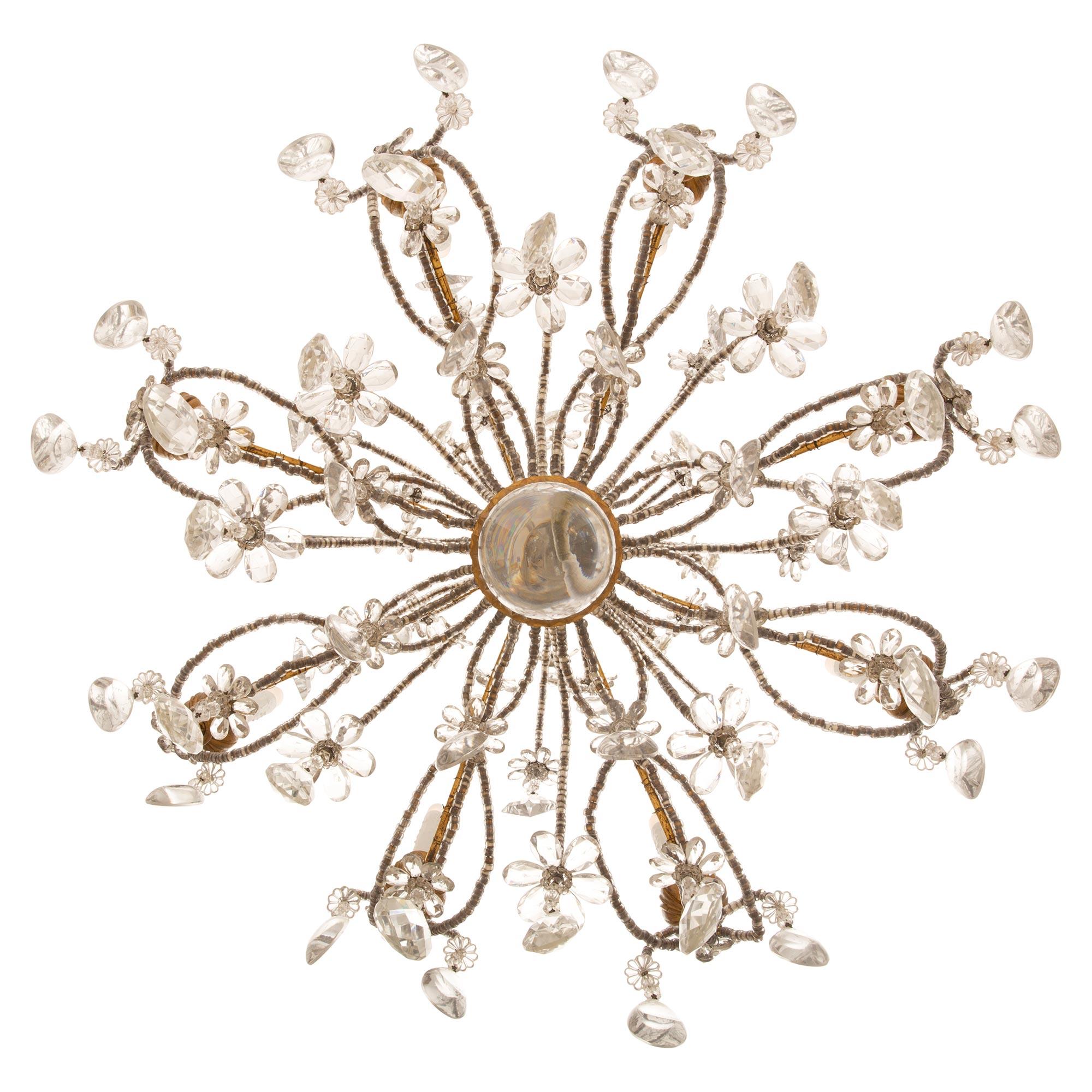 An outstanding 19th century Italian gilt wood and iron, beaded glass and crystal chandelier. This eight light chandelier is centered by a foliate carved giltwood fut with a crystal rosette and ball pendant. Eight lovely beaded 'S' scrolled gilt iron