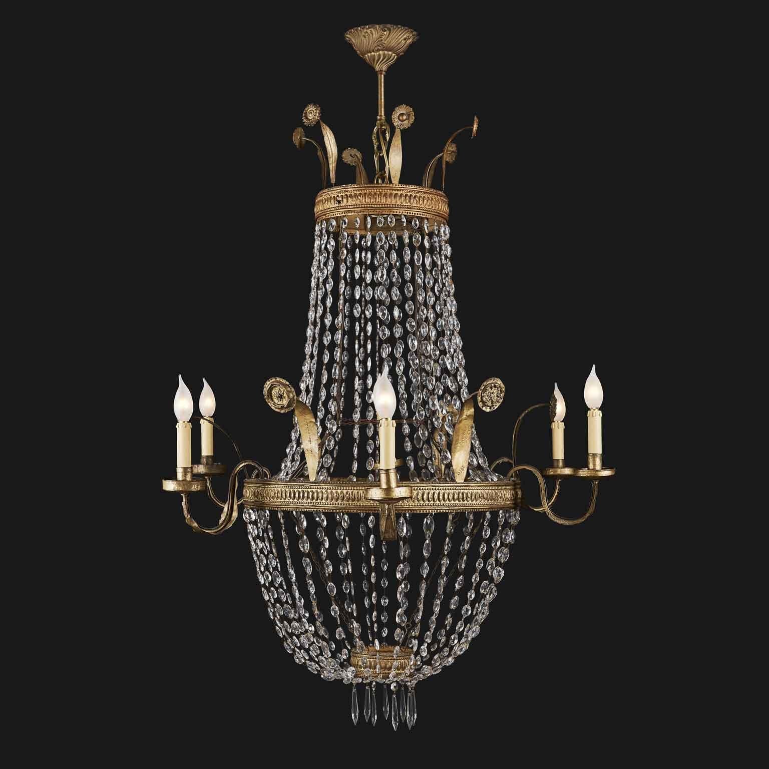 A stunning Empire Crystal chandelier of Italian origin, coming from a Tuscan private palazzo in Florence dating back to the early 19th century. 
Repoussé brass, iron and crystal are the materials of this large drop shaped Italian chandelier of