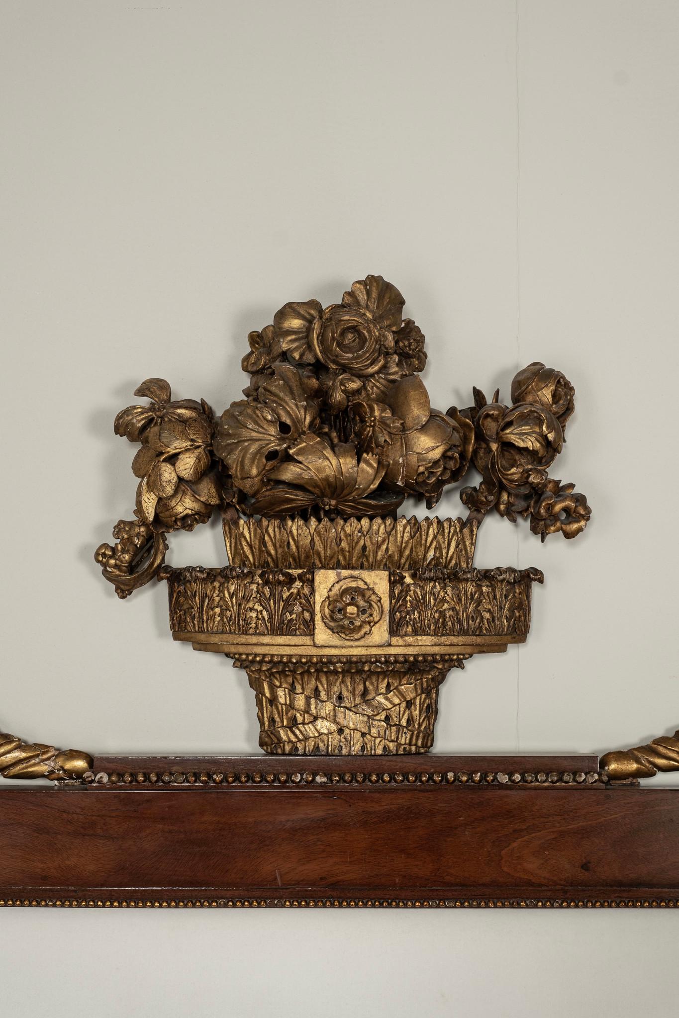 A period Italian Empire queen bed beautifully carved with Neoclassical influences to include acanthus finials, flourishing floral fauna, reeding and ribbon regalia.