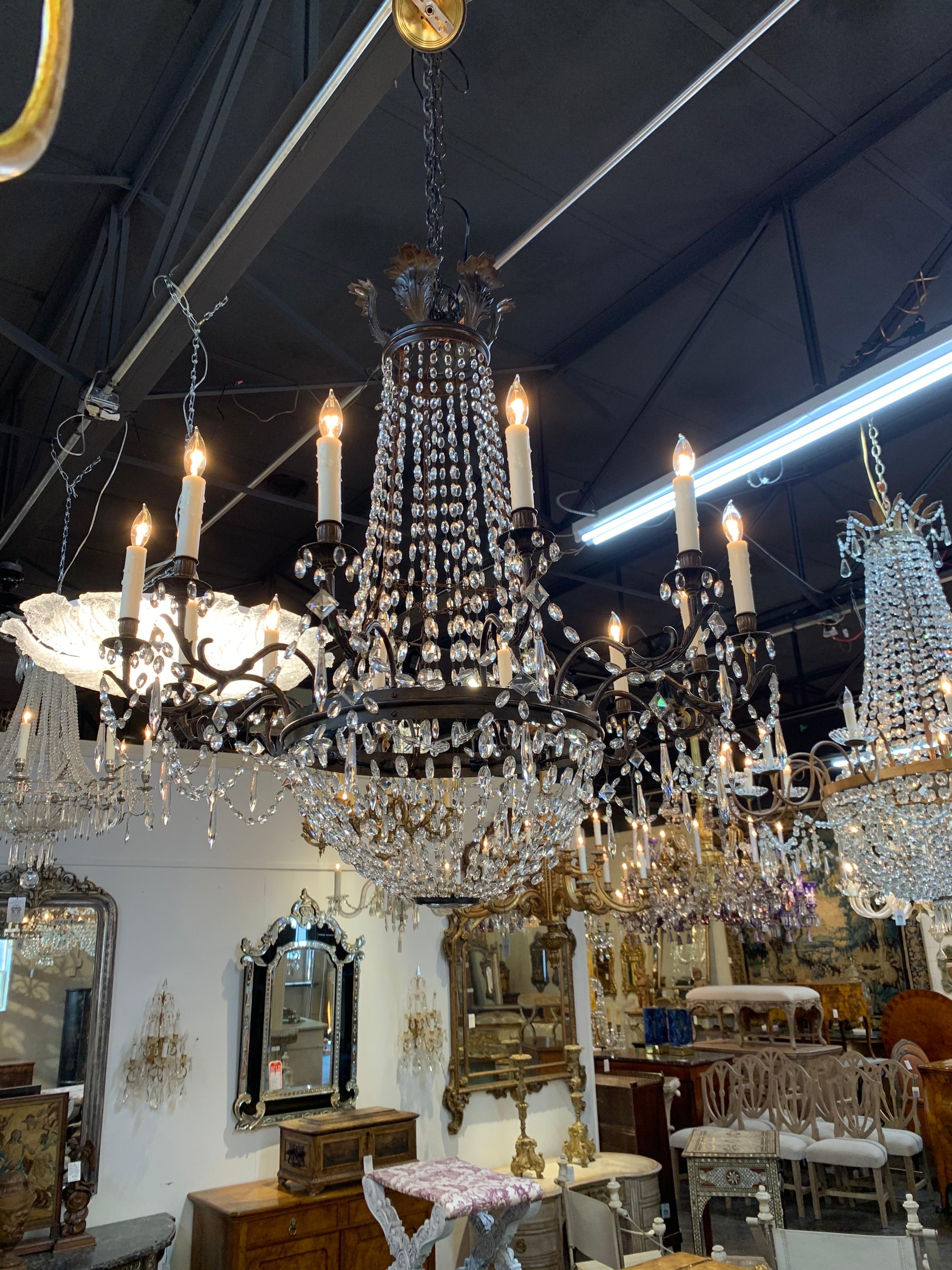 Fabulous 19th century Italian Empire style 12-light basket chandelier. The piece has beautiful glistening crystals and such an elegant look without being too formal. A true Classic!