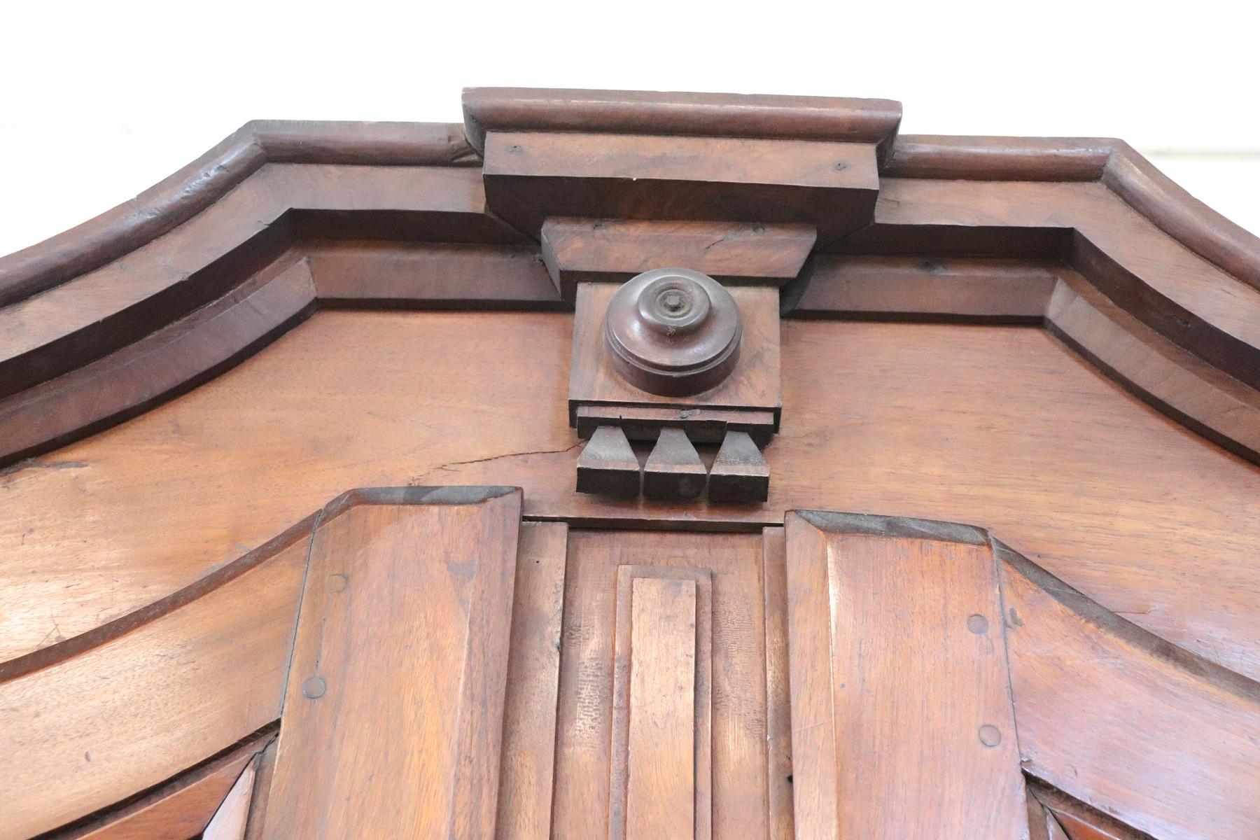 Rare and important antique wardrobe in solid walnut made in 1800s. The line typical Empire with large ebonized columns on the front. The solid walnut panels have a squared motif. Beautiful patina of walnut wood. Ample useful internal space. Wardrobe