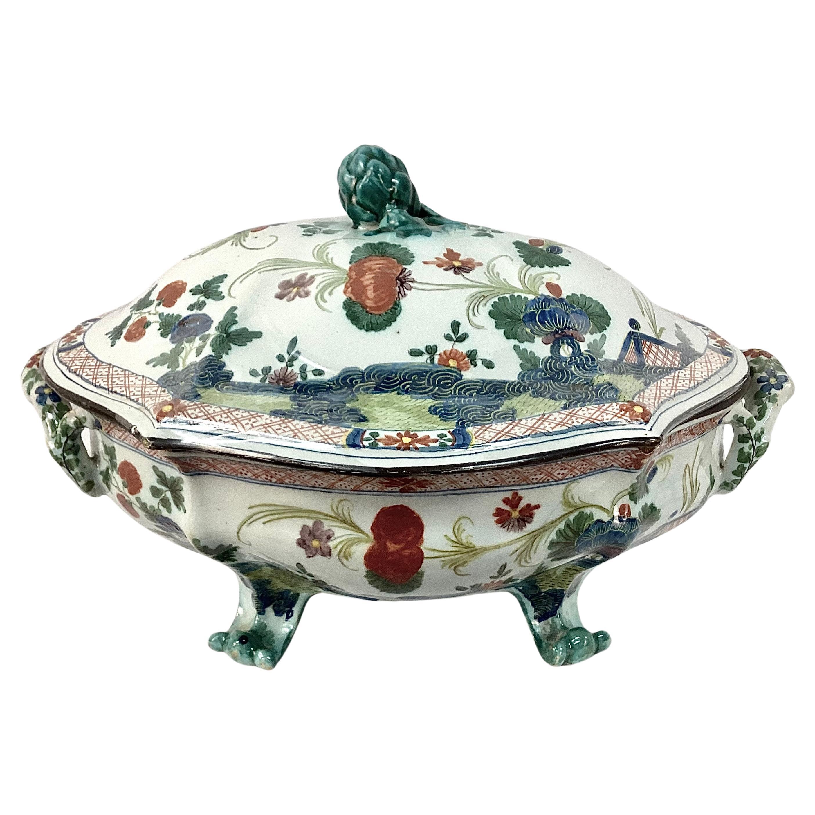Early 19th century Italian Faenza Garofano tureen with lid and handles.  Porcelain covered dish with artichoke-shaped grip. Features rich colors of green, blue and rust on a white background.  A fine and early example of Italian Faience with