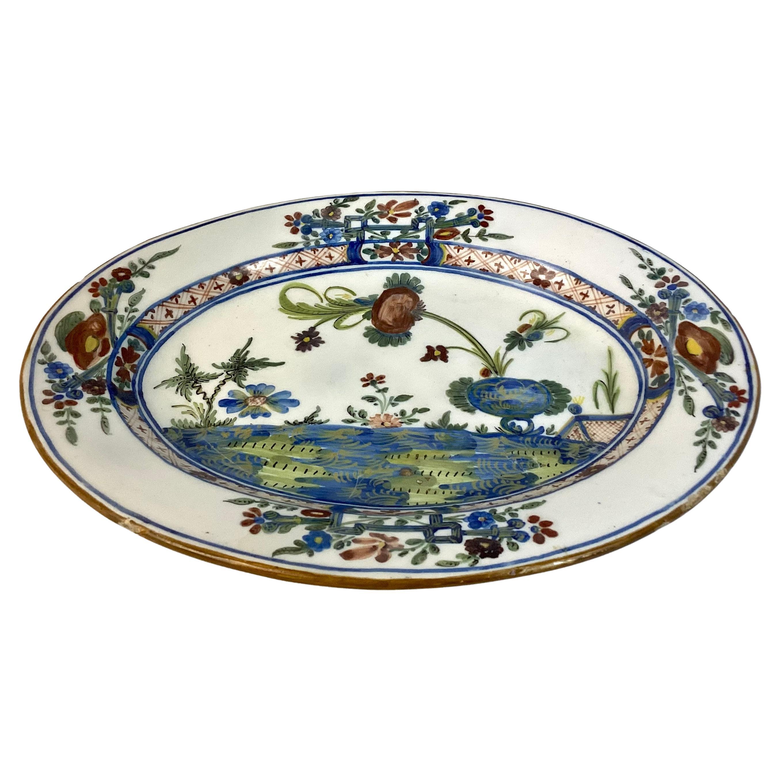 Large 19th Century Italian Ceramic Serving Platter. Platter in Faenza Garofano Blue Carnation pattern features flora in colors of blue, green, brown on a white background. Solid white on reverse side, no signature.