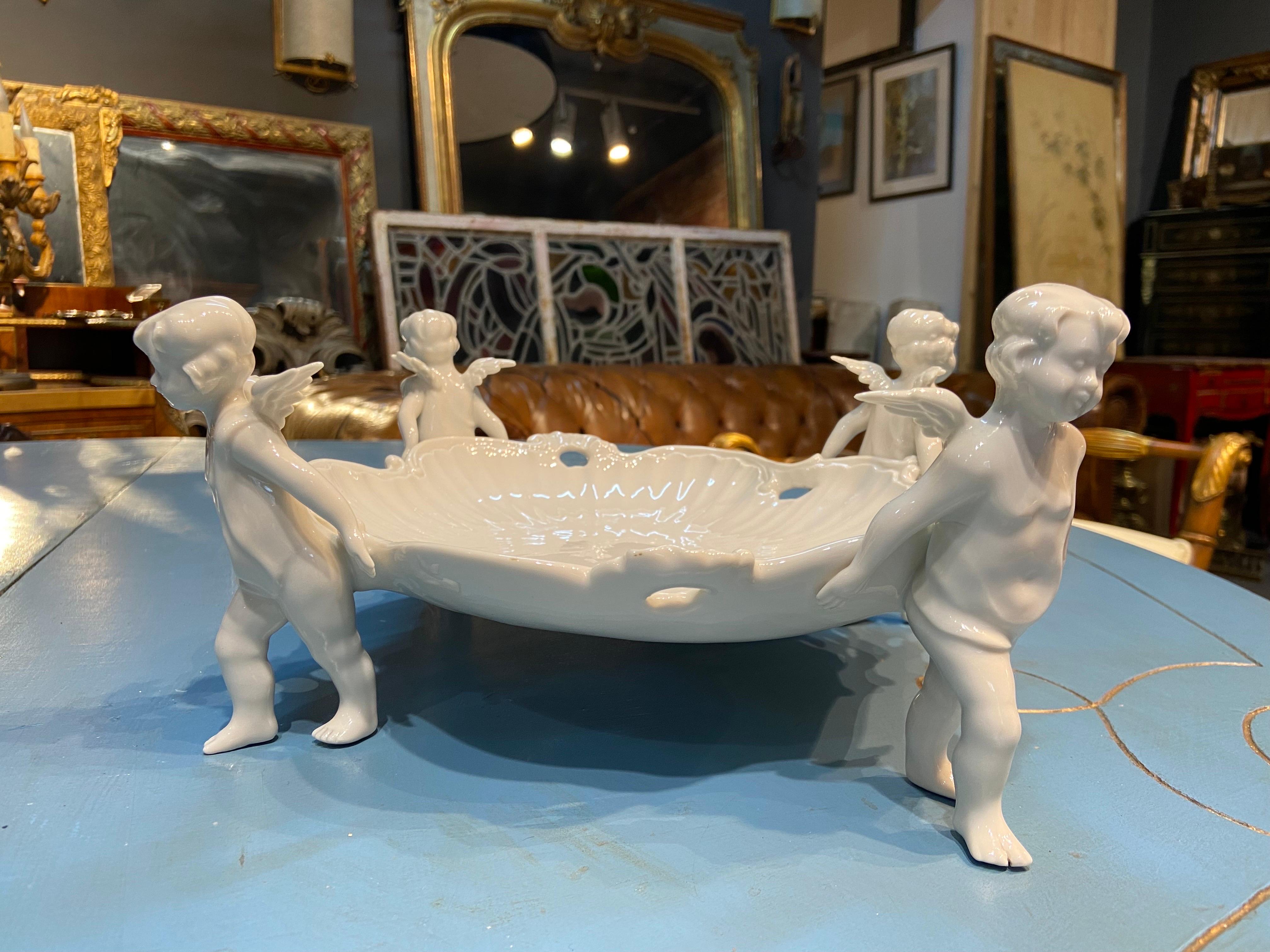 Charming center piece in fine white porcelain by Capodimonte made in mid 18th century in Italy. It represents a large plate holder by four adorable putti.
Italy, circa 1860.
  