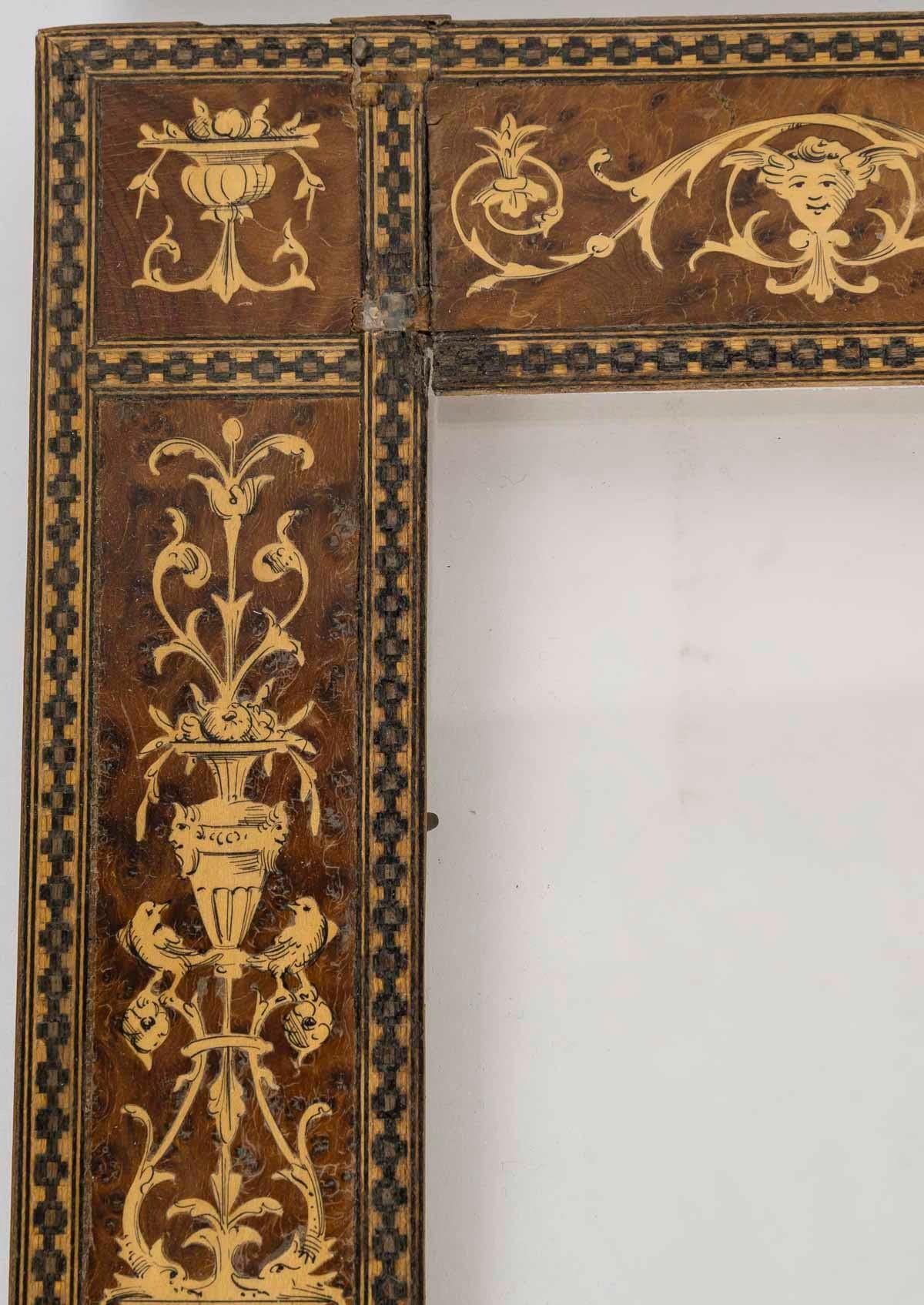 19th century Italian frame in Renaissance style wood marquetry.

19th century Italian Renaissance style wood marquetry frame.
Frame: H: 25.5cm, W: 20cm, D: 1cm
Interior view: H: 14,8cm, W: 10cm
