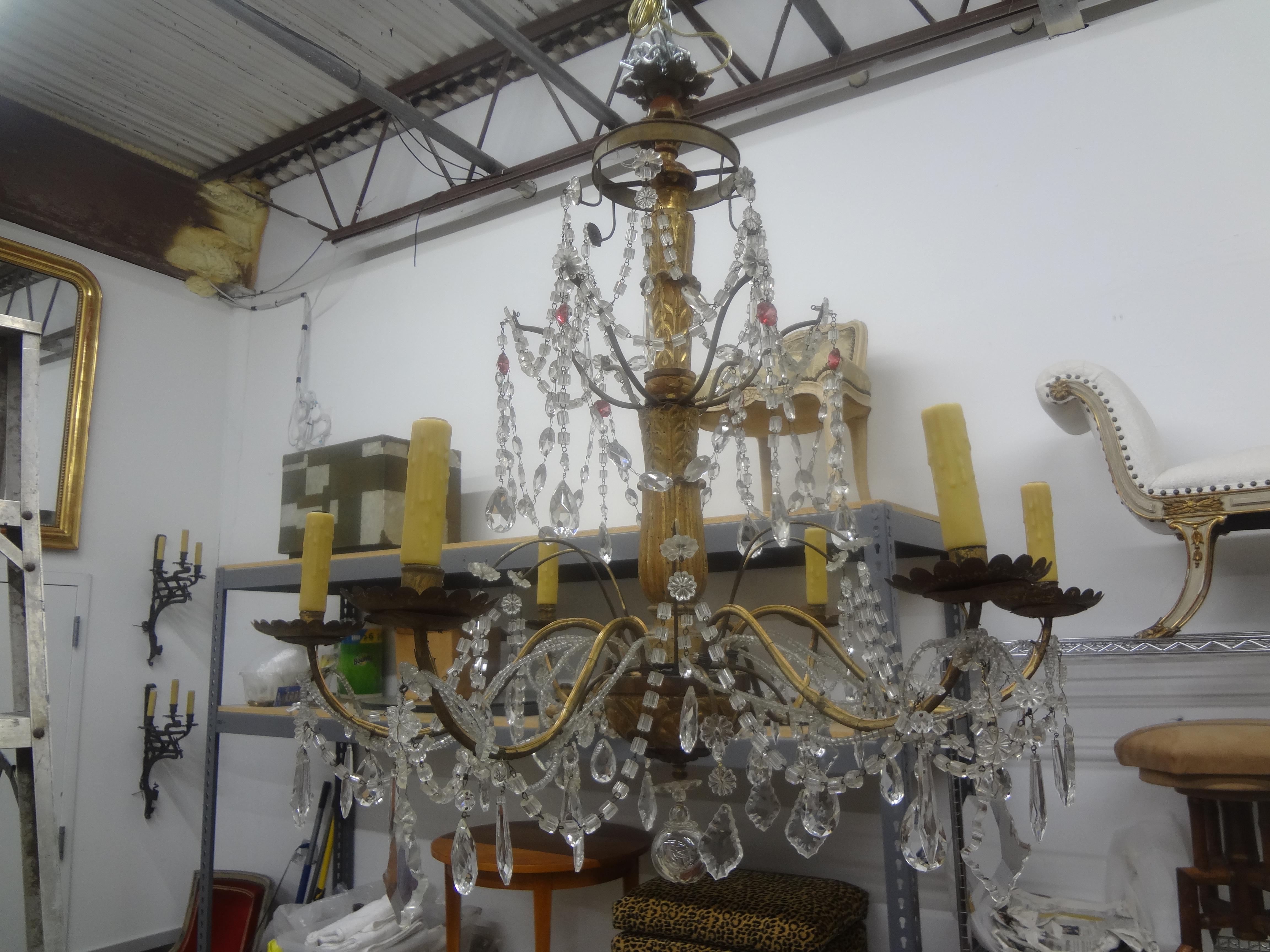 19th Century Italian Genovese Giltwood and Crystal Chandelier.
Stunning antique Italian Genovese gilt wood and crystal six arm chandelier. This lovely crystal chandelier has unusual pink crystals and has been newly wired with new sockets for the
