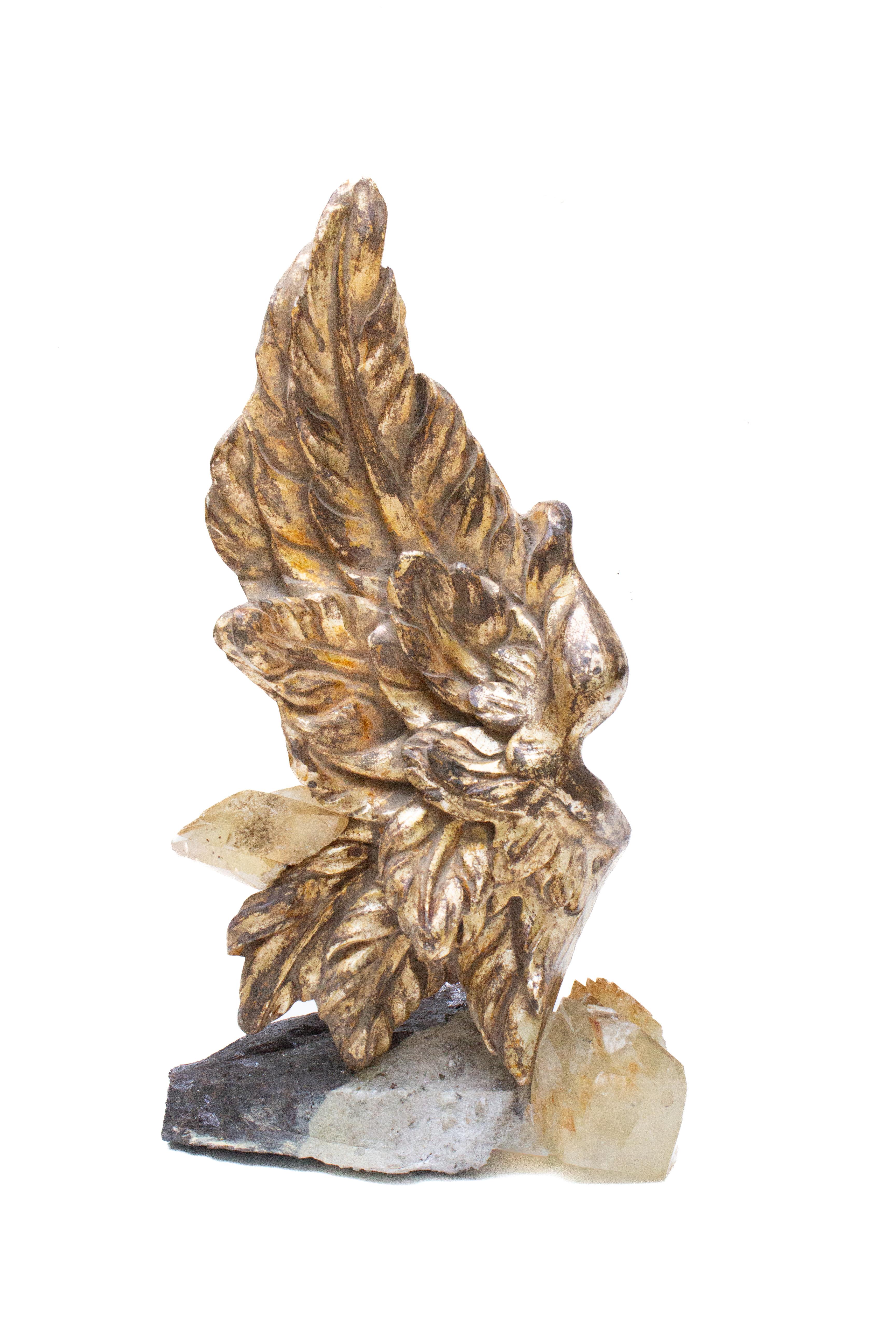 19th century Italian hand-carved gilded angel wing with calcite crystals and sphalerite.

The hand-carved gold leaf angel wing is originally from a church in Tuscany. The ecclesiastical artifact is adorned with calcite crystals in a matrix of