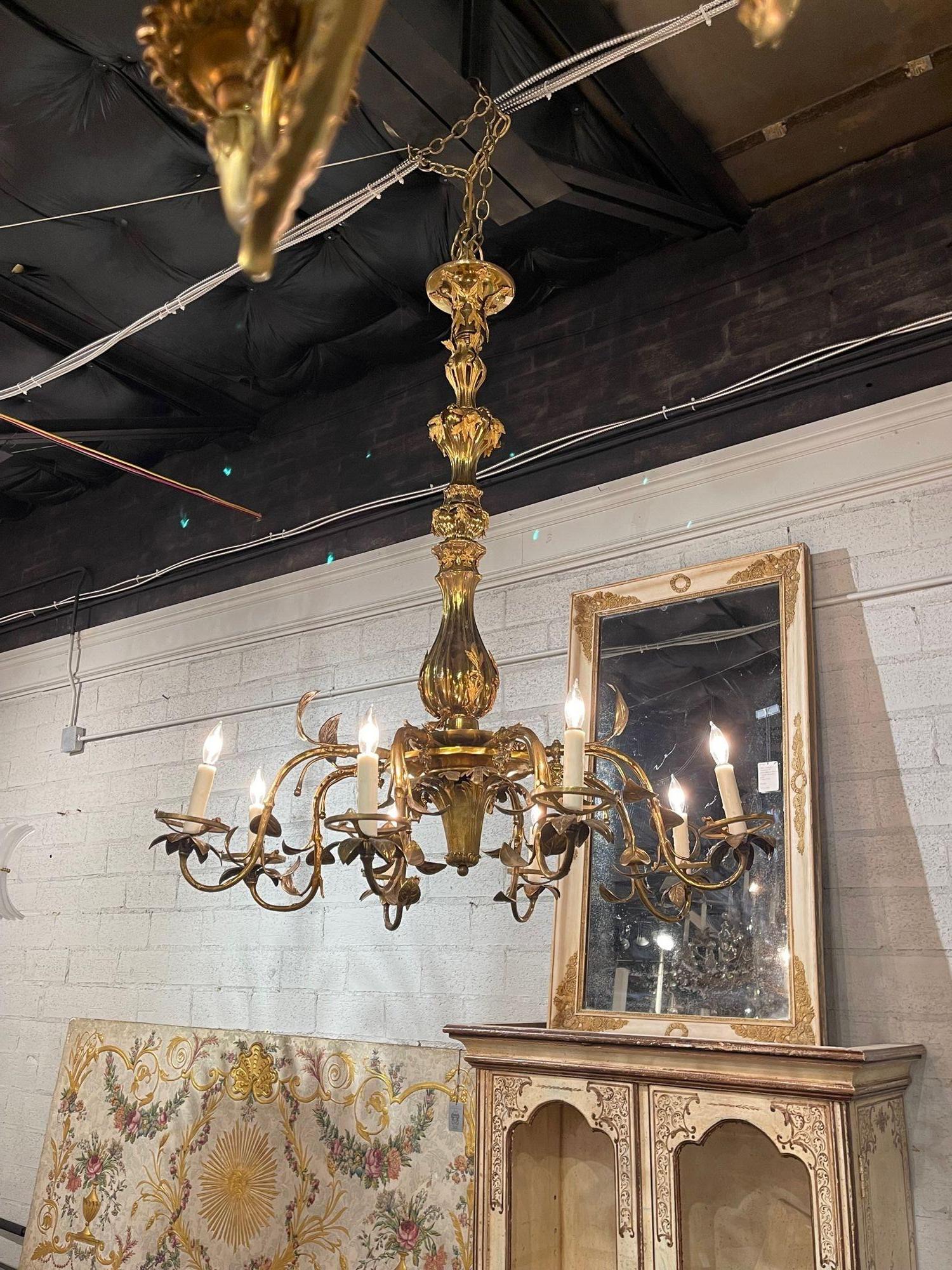 Elegant 19th century Italian gilt bronze 8 light chandelier. Beautiful details on the arms and base. A great addition for a designer look!