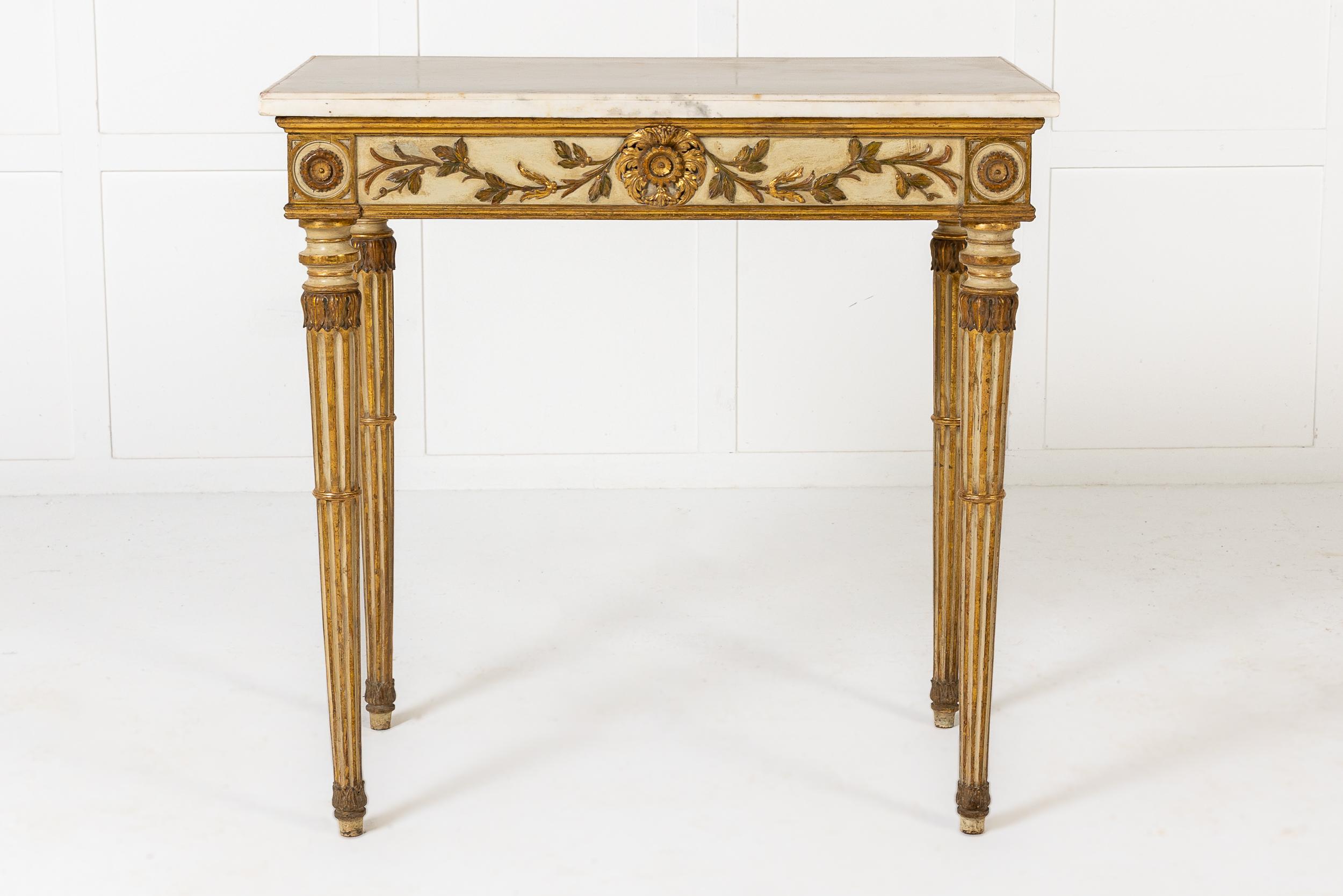 An Early 19th Century Italian Parcel Gilt Side Table of Small Size and Fine Proportions.

This table is decorated throughout in its original white/cream and gilt scheme. Originally intended to be a pier table, this piece would have stood between the