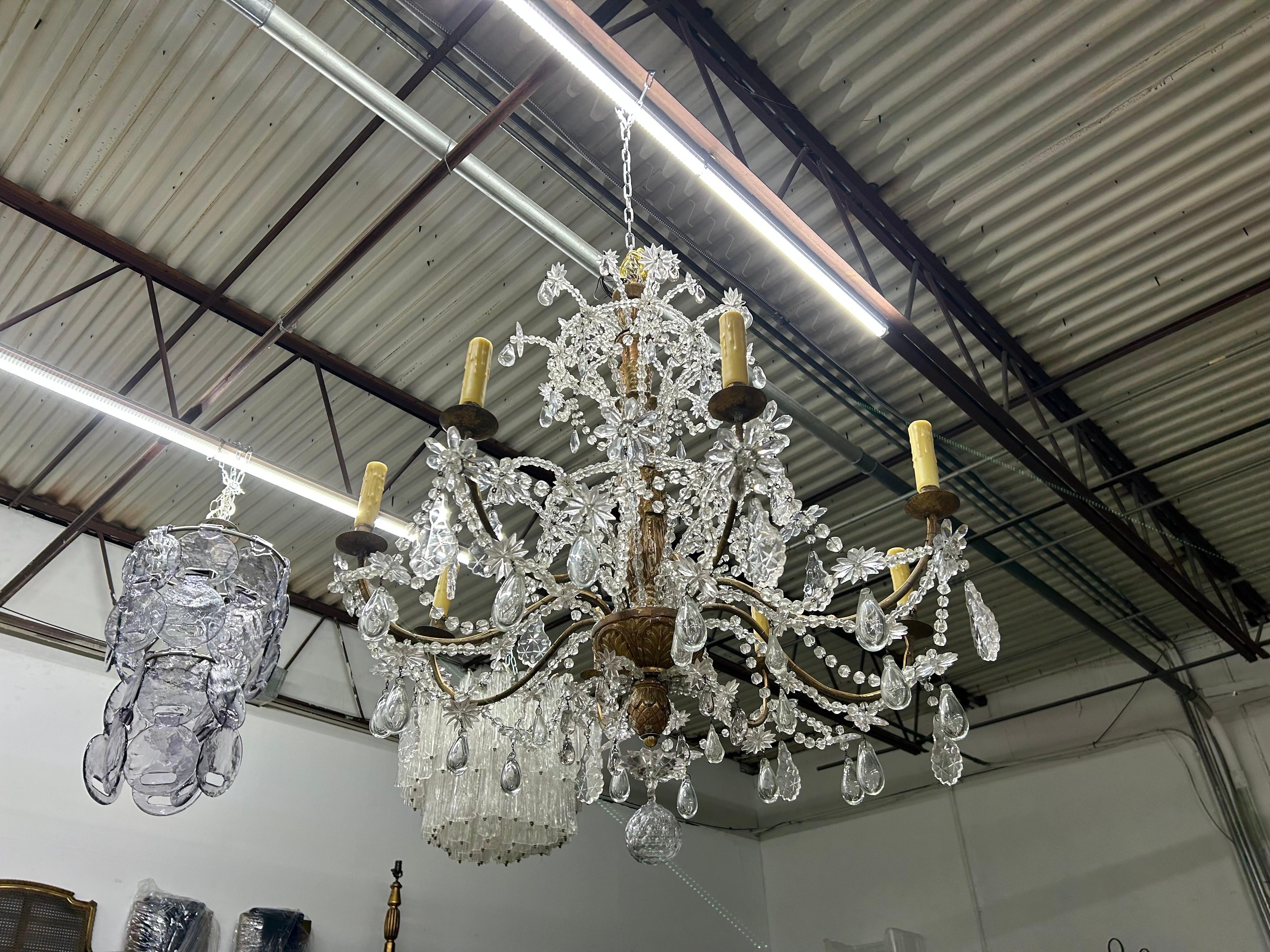 19th Century Italian Giltwood And Crystal Genovese Chandelier.
Our stunning 19th century Genovese chandelier has a central giltwood column with eight arms displaying beautiful crystals with an open field.
This stunning antique Italian crystal