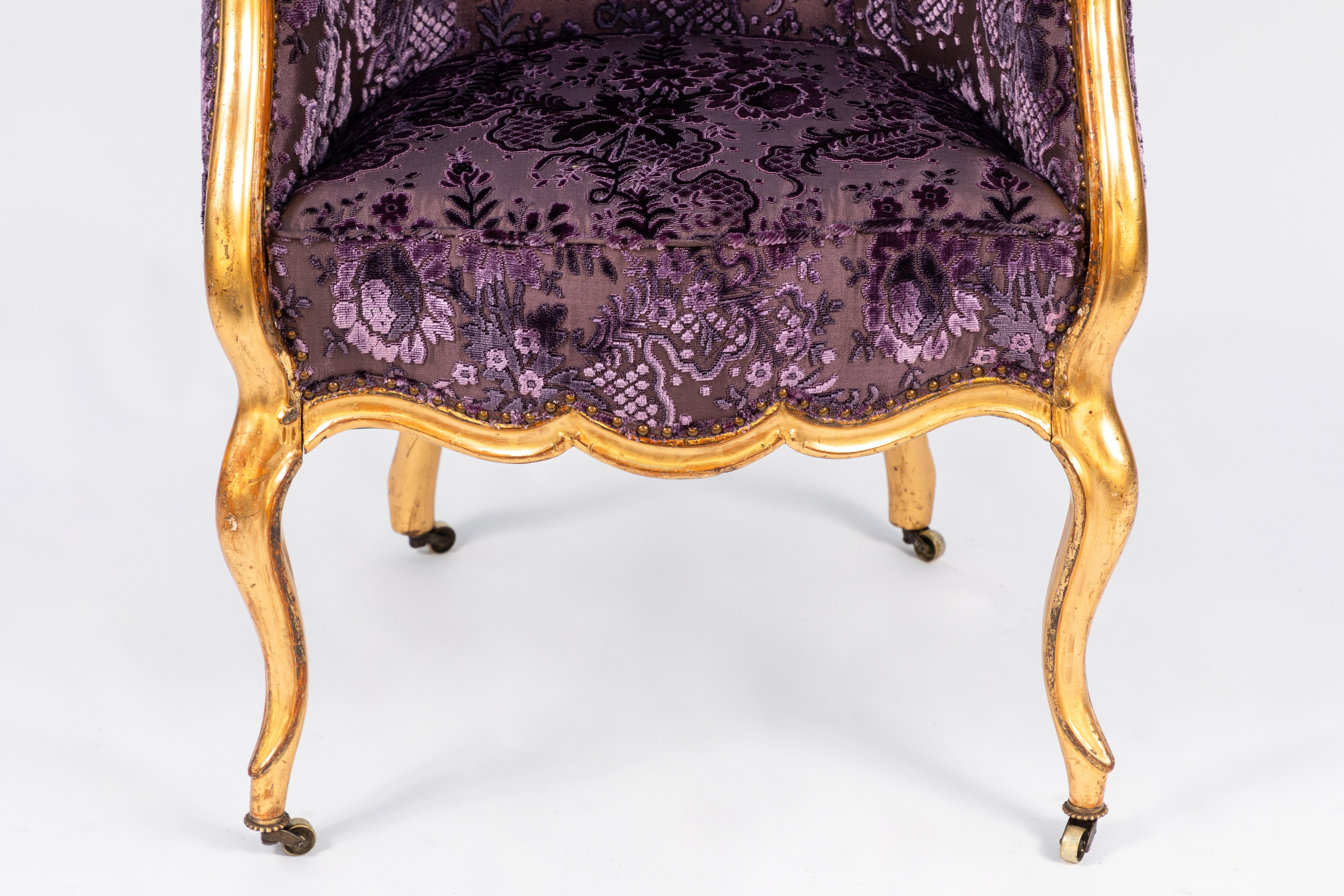 19th century Italian giltwood single armchair with finely carved details. Newly upholstered in bright purple velvet.