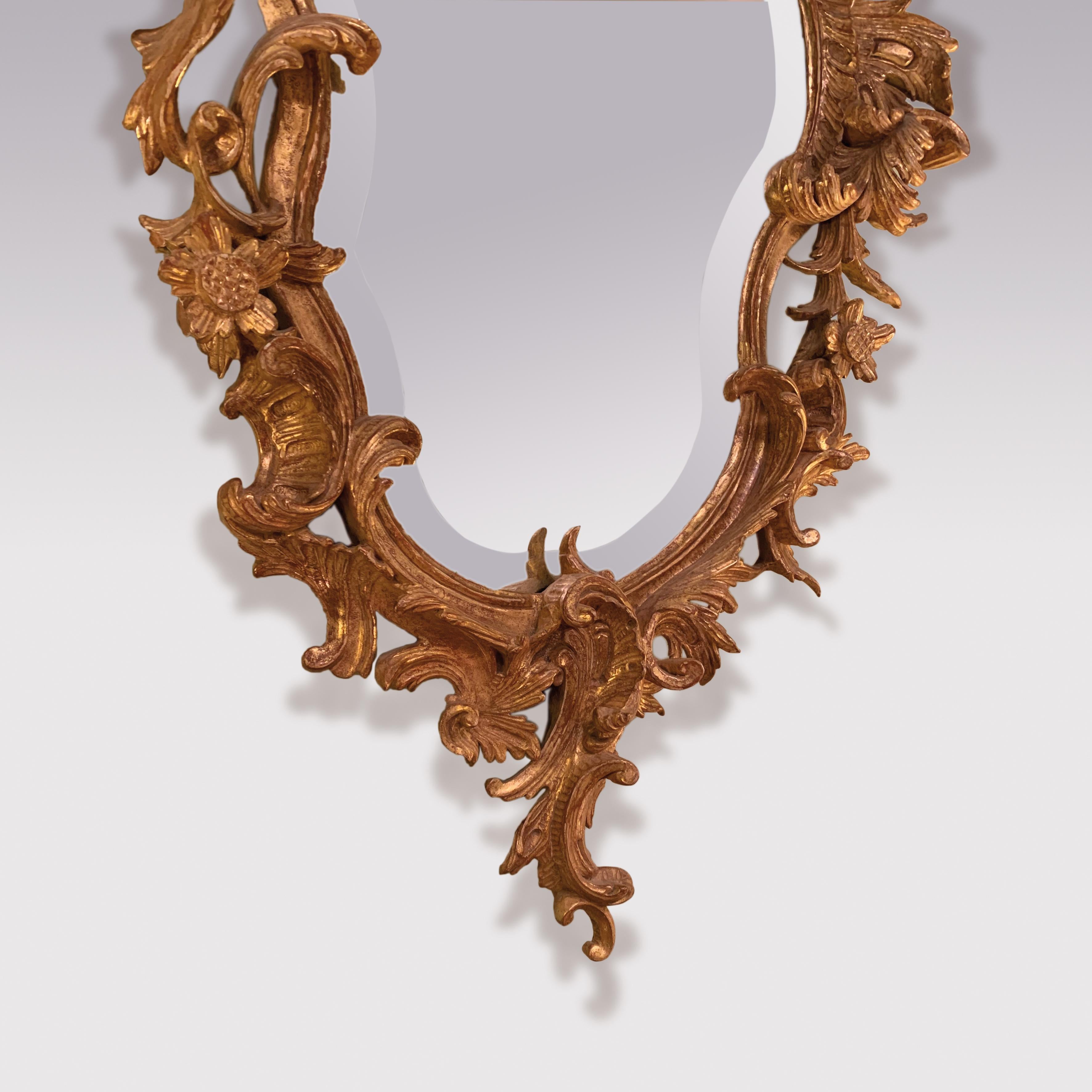 An attractive late 19th Century Italian girandole Mirror, crisply carved with “C” scrolls, flowers and foliage, retaining original bevelled mirror plate.