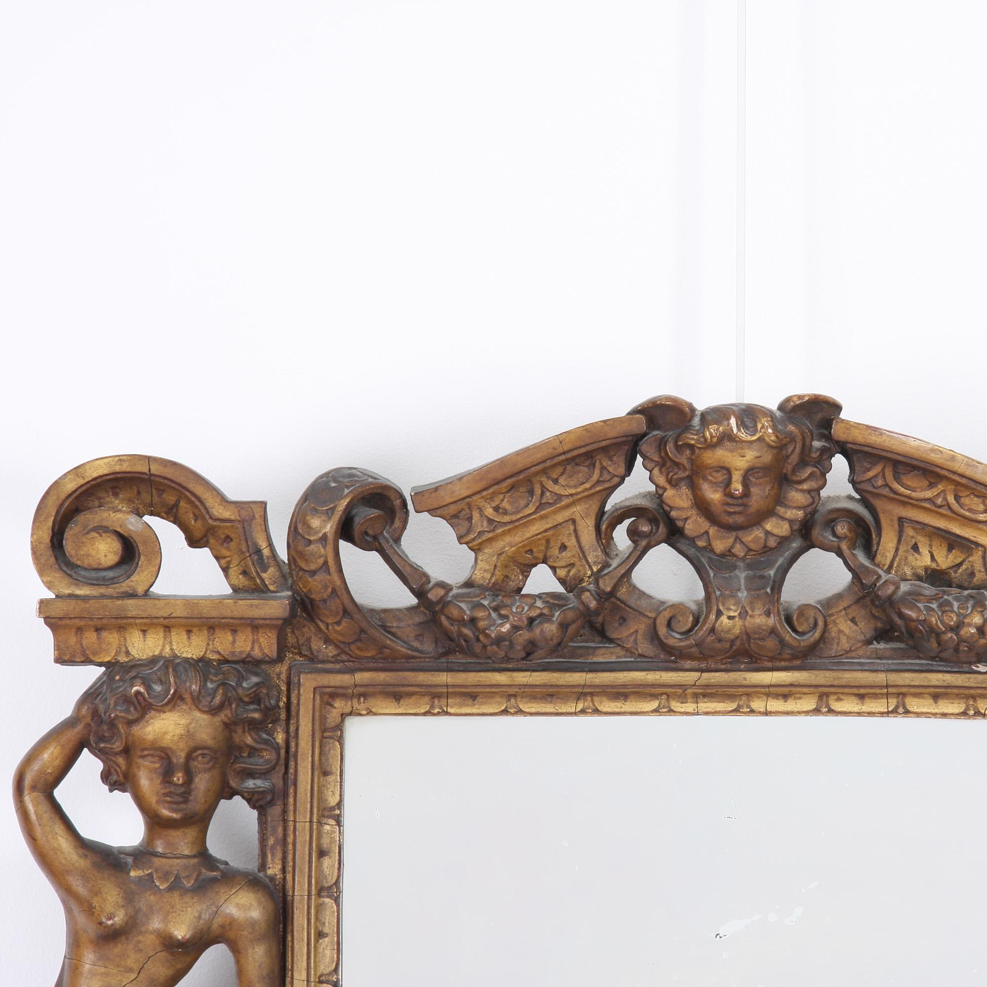 This fantastic giltwood mirror dates back to 19th century, Italy. With charming details, from flanking female figures on the frame to a charming cherub adorned with an Elizabethan ruff, this piece is a stunning addition to any home.