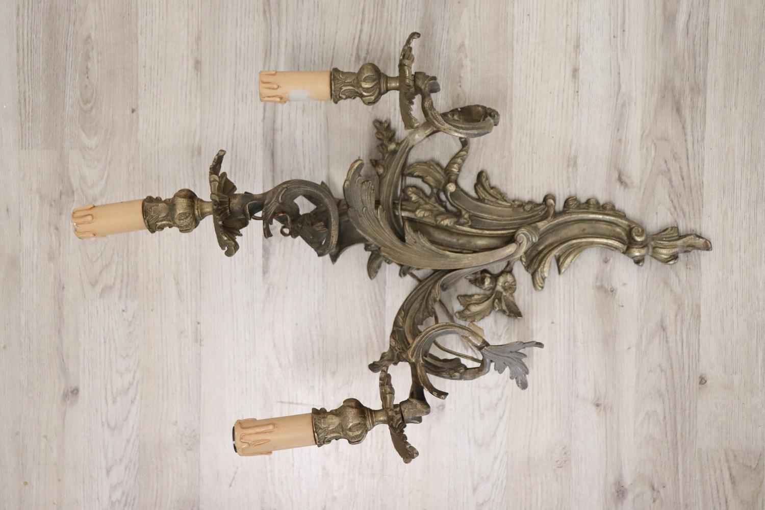 Beautiful and refined Italian circa 1890s pair of wall lights or sconces three lights. Made of golden bronze. Art Nouveau decoration with leaves that rise up in volutes and support the lights. Very decorative and large perfect for your wall. The