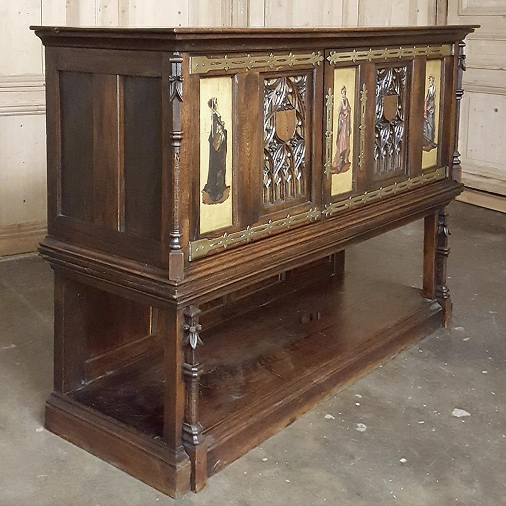 This handsome 19th Century Italian Gothic painted buffet ~ cabinet was hand-crafted from solid walnut, then given a gilded and painted finish and finally lavished with brass hinges and keyguards for a truly unique look! Intricate Gothic motifs