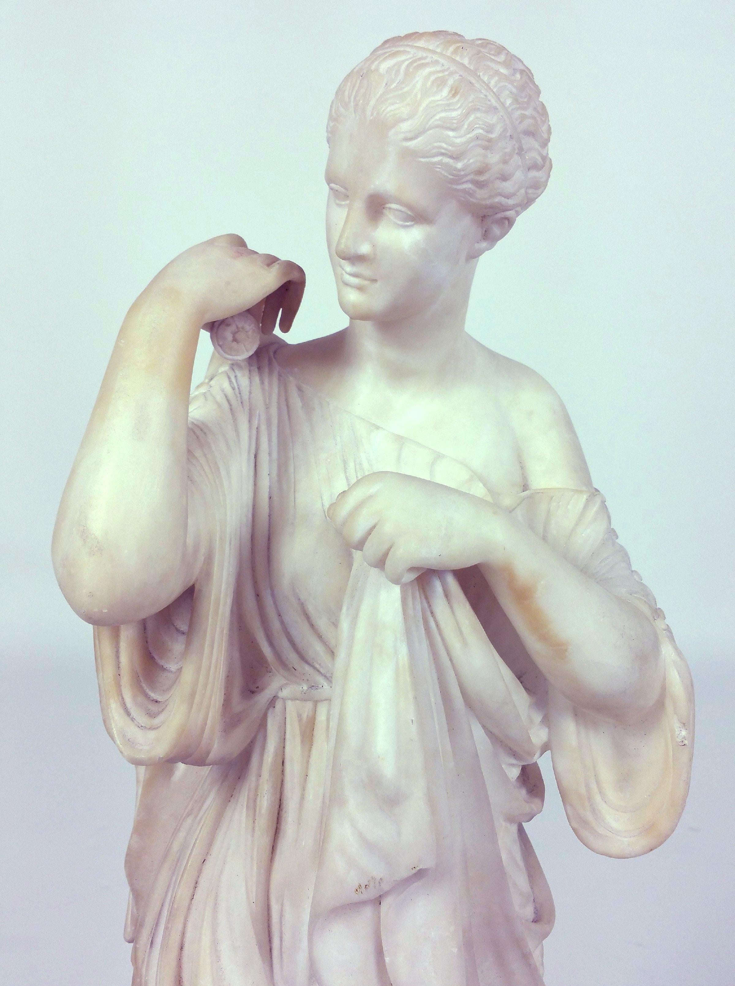 This exquisite and finely detailed 19th century Italian Grand Tour carved marble figure is of a maiden, after the antique. She measures 7 ¼ in – 18.4 cm wide, 6 ½ in – 16.5 cm deep and 28 in – 71.1 cm in height. This beautiful sculpture would
