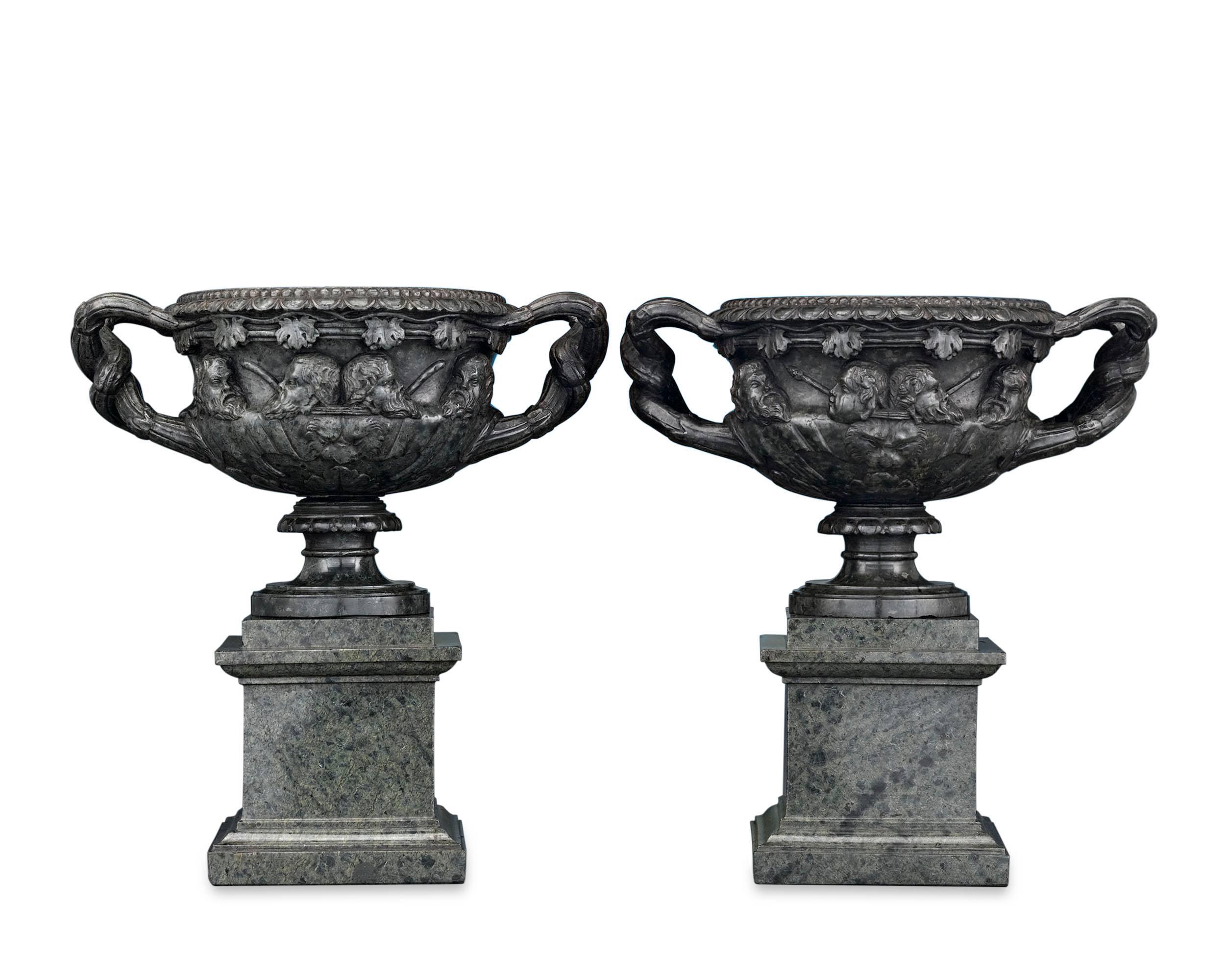 This remarkable pair of carved green serpentine marble vases were modeled after the legendary Warwick vase. Found at the Roman Emperor Hadrian's villa in 1770 and subsequently held in the collection of the Earl of Warwick, the vase remains one of
