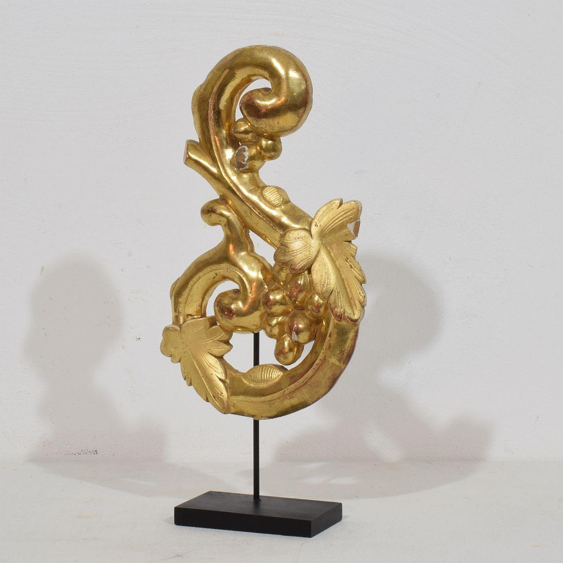 Beautiful handcarved giltwood baroque style ornament that once adorned a chapel or a church.
Italy, circa 1850. Weathered and small losses. Measurement includes the wooden base.
H:31,5cm  W:15cm D:5,5cm 