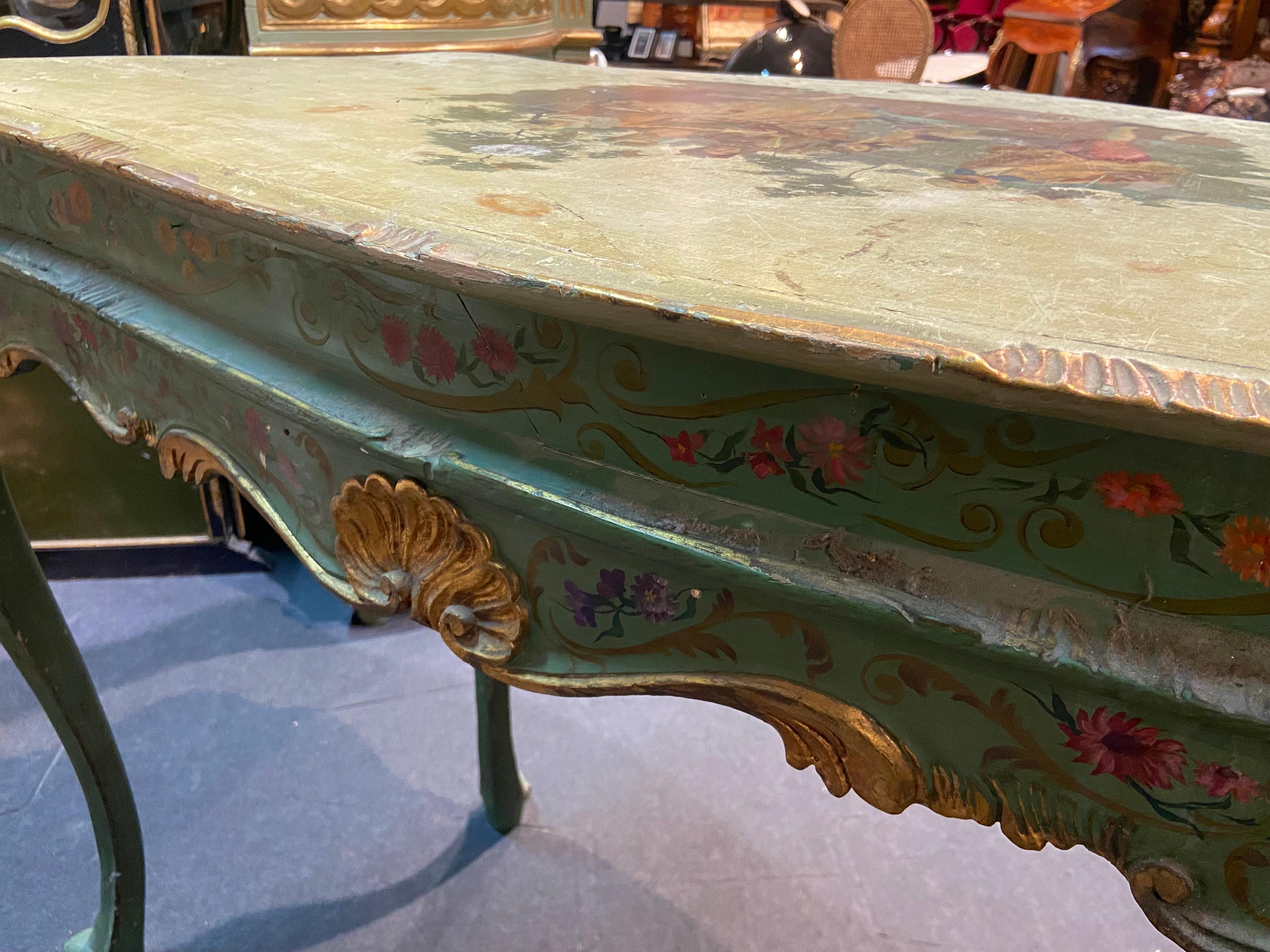 Italian hand carved and lacquered wood console. Inspired by Venetian style and colours it is decorated with floral elements and gilt wood parts and is beautiful at front as much as at the back. Could be used as a console or as a centre piece as