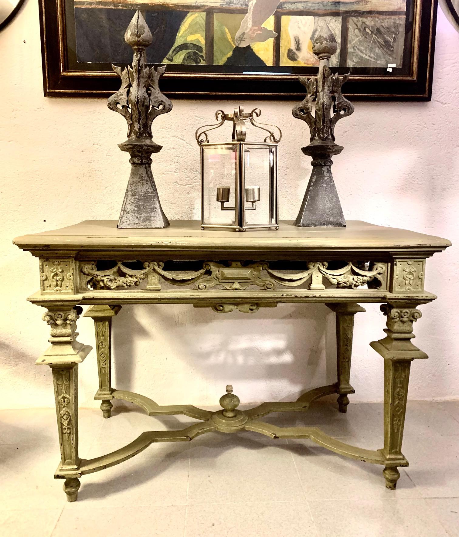 Very elegant French console table, entirely hand painted. The upper part is trapezoidal in shape, with cantilevered corners. The square and conical legs of the baluster are joined by an X-shaped frame, topped with a large central finial. Raised on