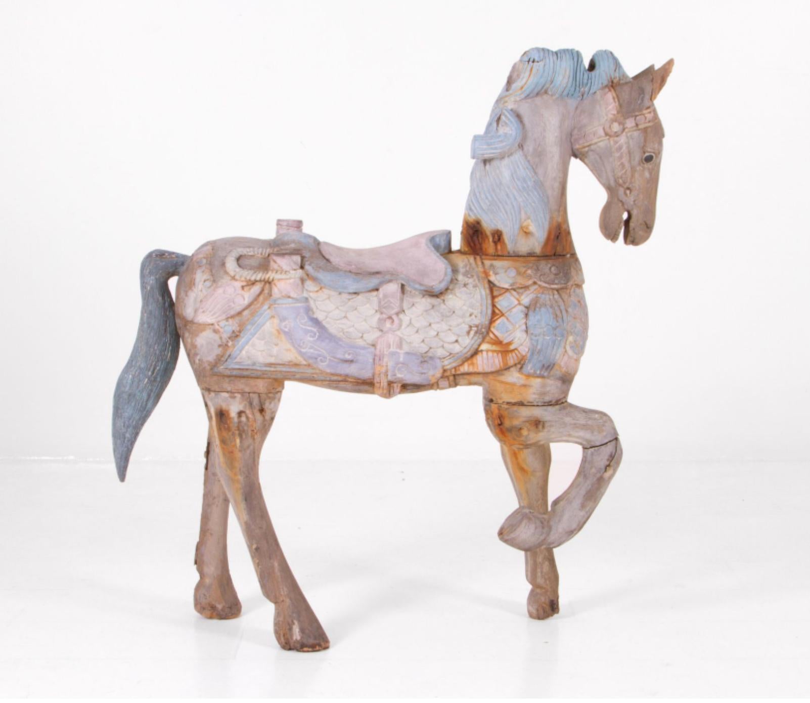 Extraordinary hand carved rocking horse made in Italy at the end of 19th century. The piece is still wearing its authentic paint in light blue, rose and velvet. The condition is fine and the wear is consistent with the age and use. There were no