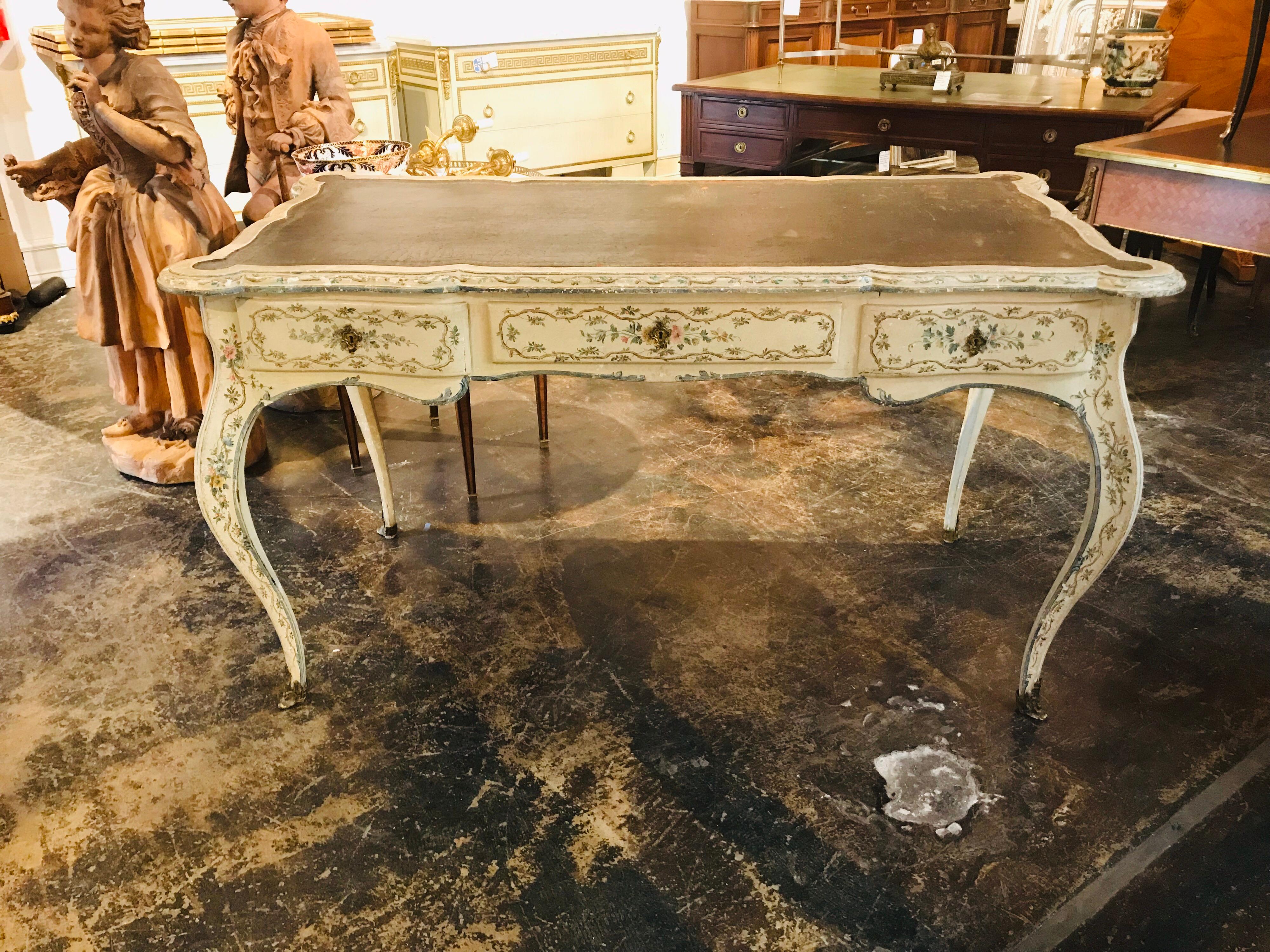 Beautiful Italian painted desk with original leather top and bronze hardware. Nicely aged patina that shows normal signs of age and use. Hard to find large scale with plenty of leg room below. The table could also serve as a center table or a