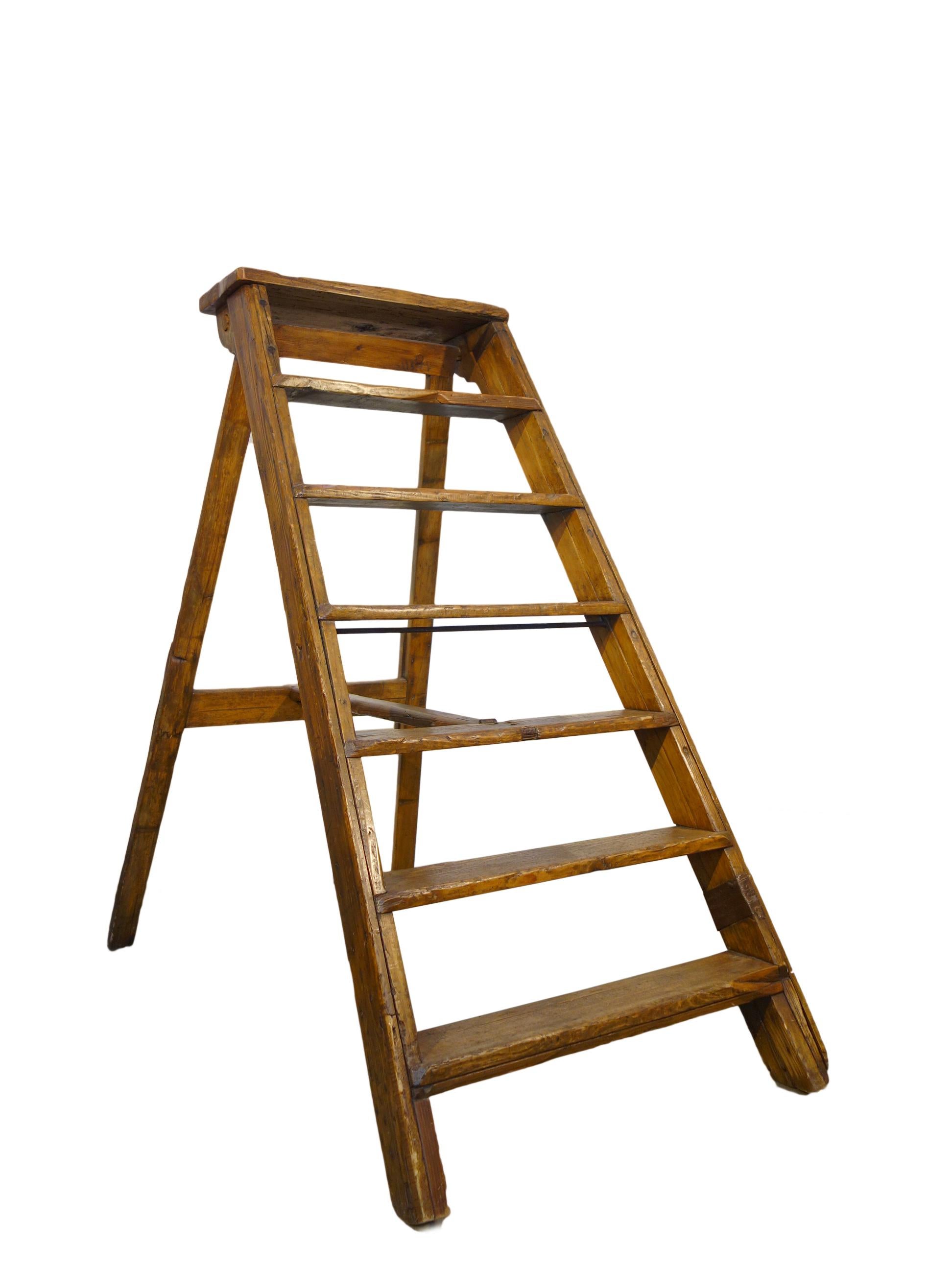19th century Italian handcrafted rustic wood folding library stair ladder, Tuscany, circa 1860.
Measures extended: 52” H x 29” W x 53” D
Closed 64” H x 29” W x 9” D.
 