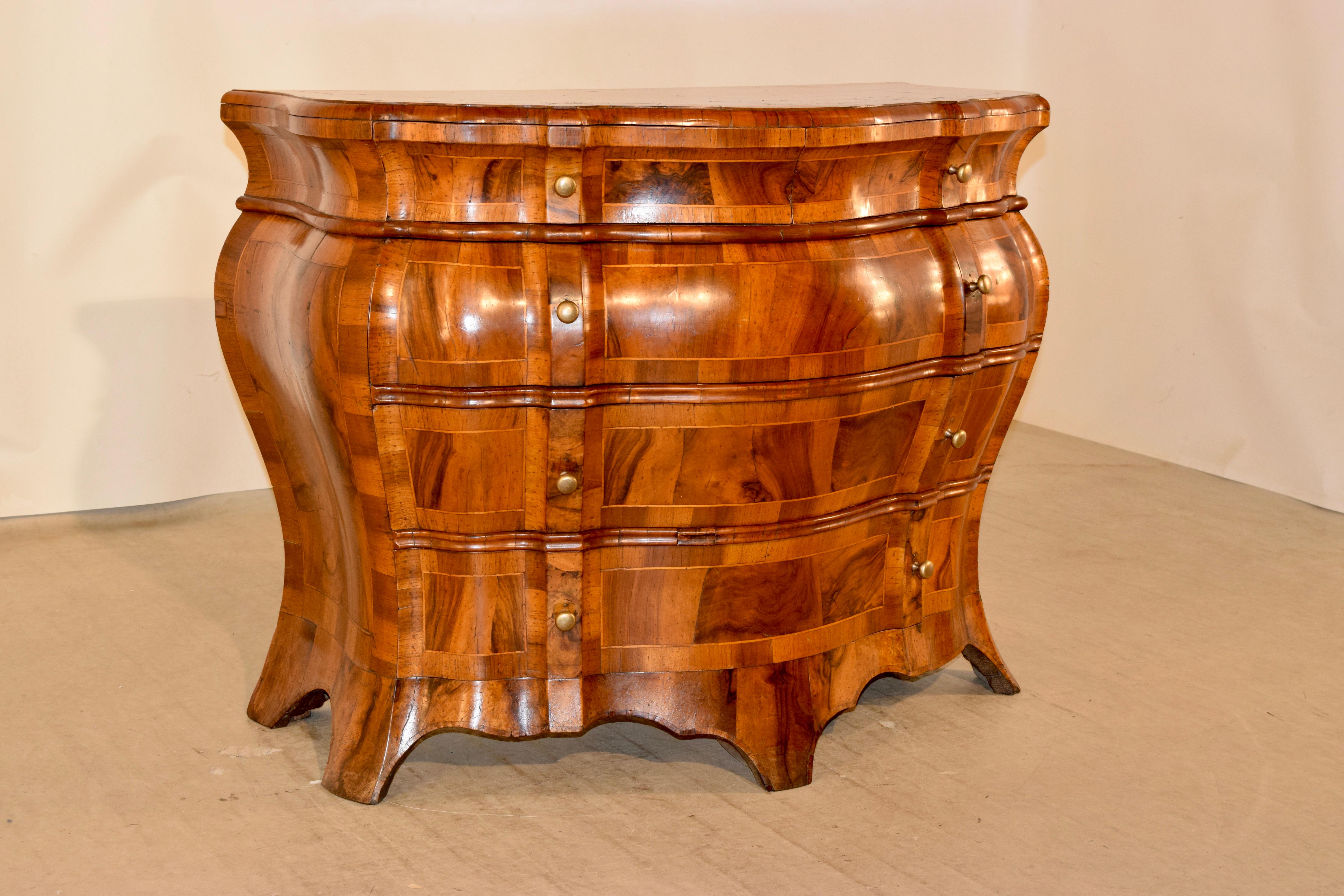19th century inlaid bombe commode from Italy made from olive wood. The top is banded and has book-matched veneers. The case has two over three drawers with repeating banded inlays and banded inlaid side panels. The case is supported on shaped