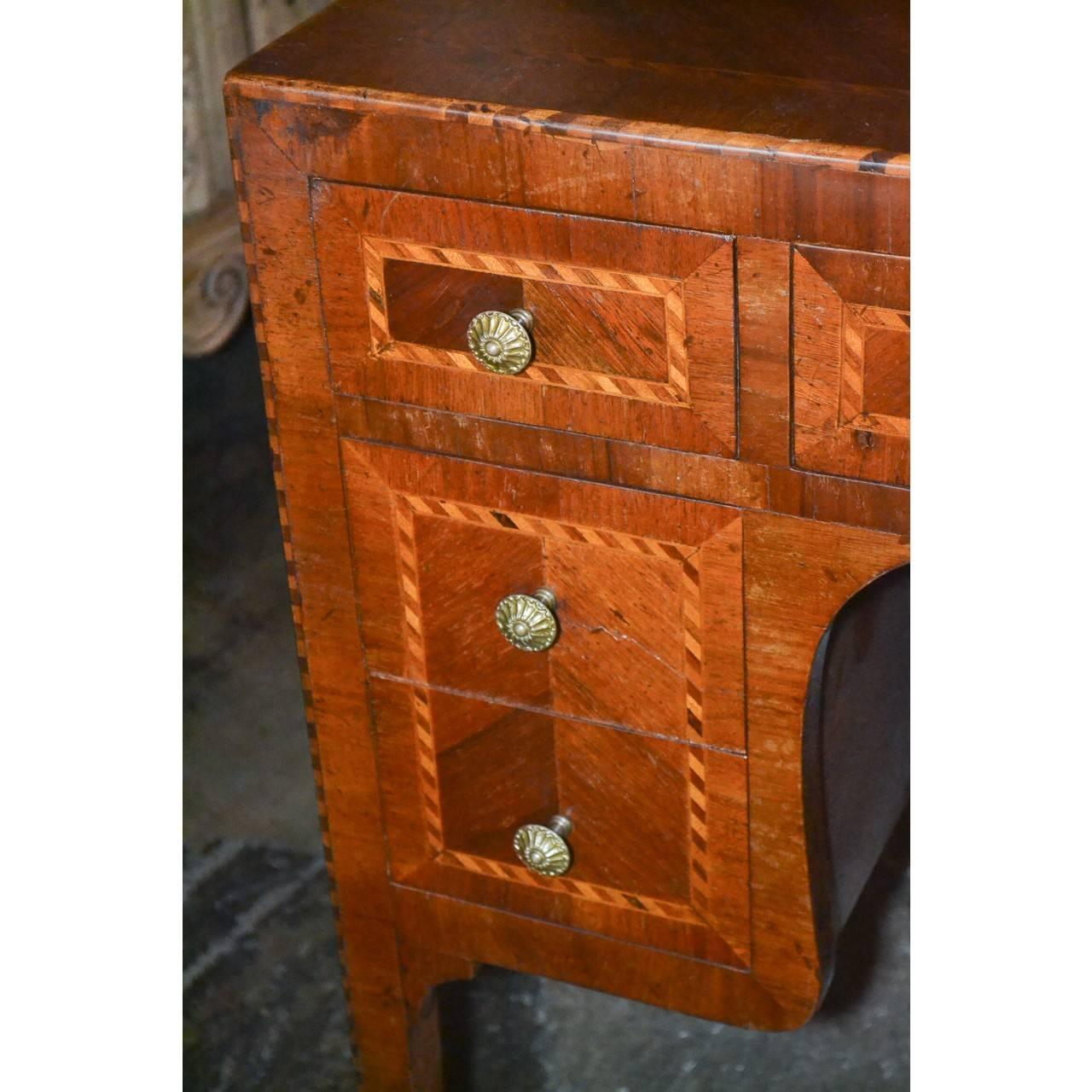 Absolutely gorgeous 19th century Italian mahogany, kingwood, and rosewood vanity or desk with superb parquetry inlays and matching veneers. Nicely contoured knee-hole and inset with seven drawers. Finished in the round with a delicately