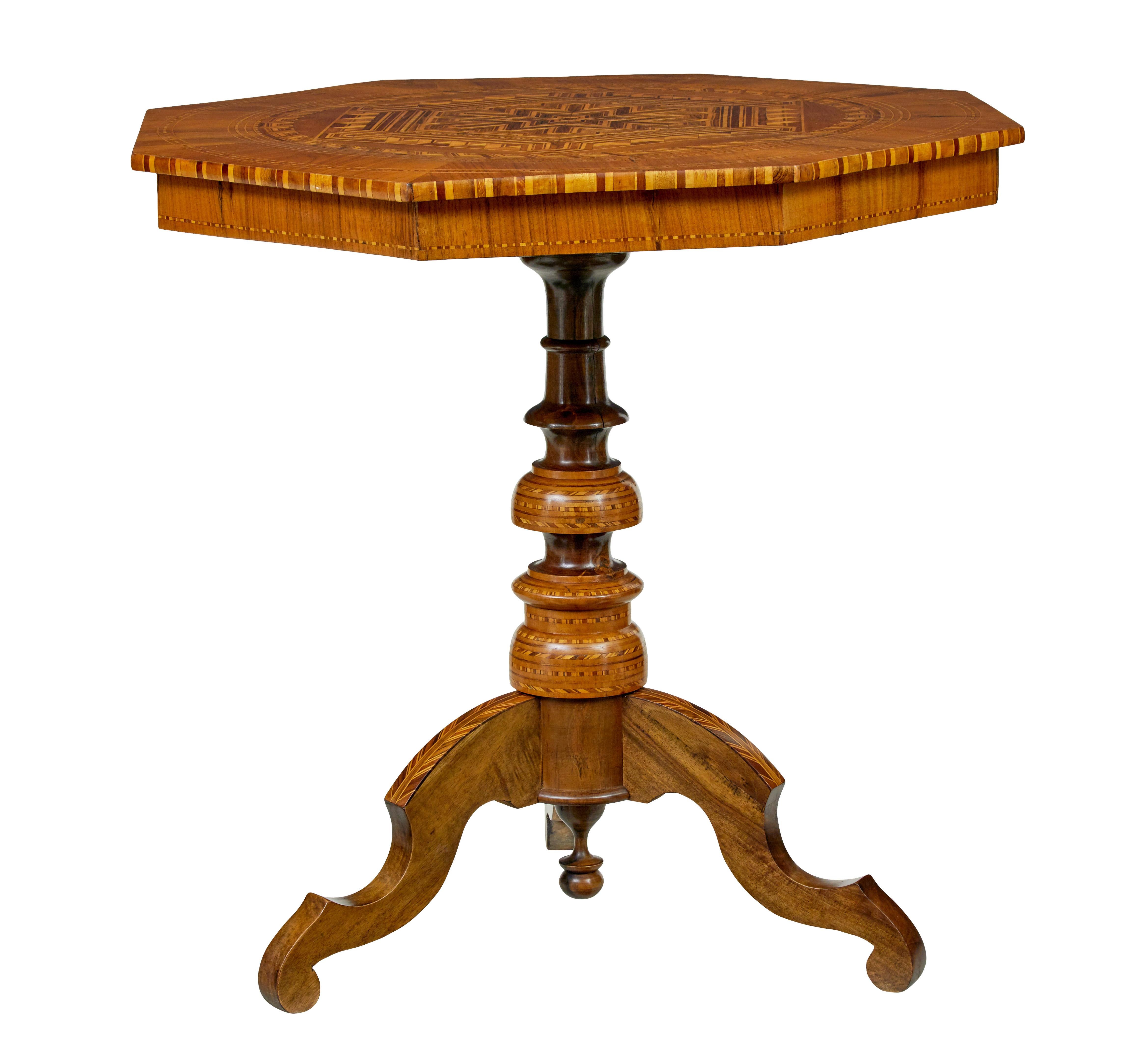 19th century Italian walnut Sorrento table circa 1890.

Good quality octagonal shaped inlaid Sorrento table.

Profusely inlaid and strung with a geometrical design to the top surface and around the frieze.  Raised on a turned stem and 3 scrolled