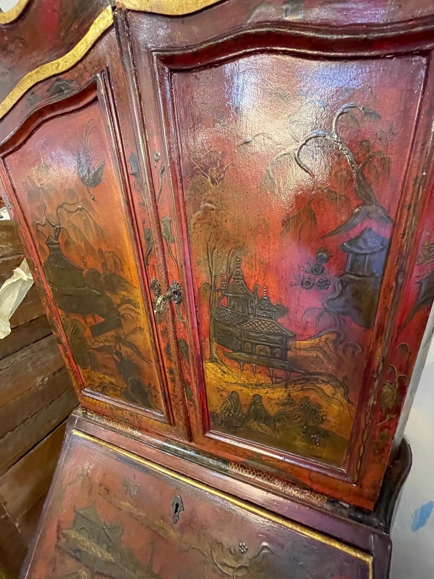 Extraordinary rare 19th century Italian lacquered red secretary with raised chinoiserie design. Beautiful Asian images on the outside of the cabinet and also on the inside. Opens to reveal storage compartments and a desk surface. Three drawers for