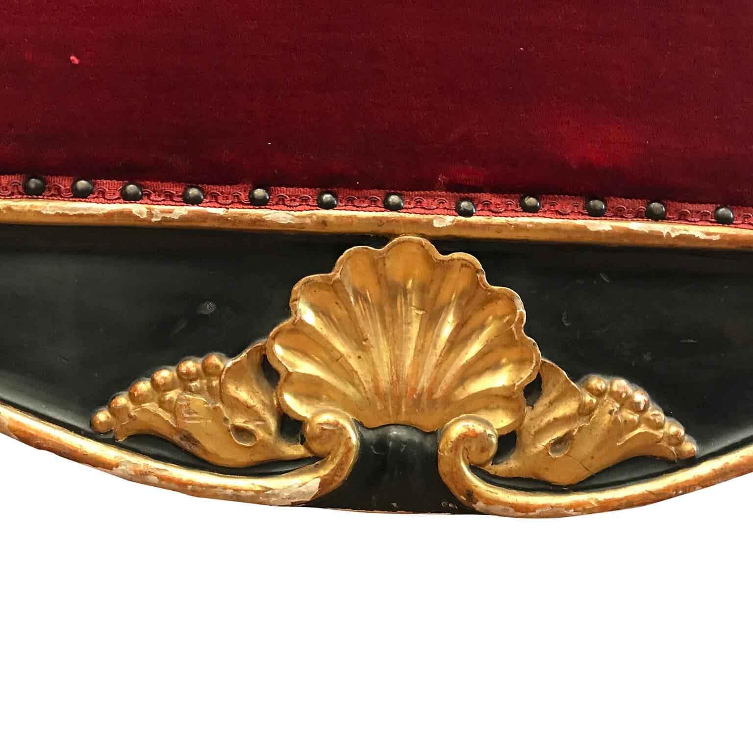 Antique Italian sofa from Sicily a Louis Philippe poplar sofa dating back to the last quarter of 19th century, with a dark lacquer serpentine back frame decorated with an elegant vegetal hand-carving with gilt roses centered by a shelled gilded