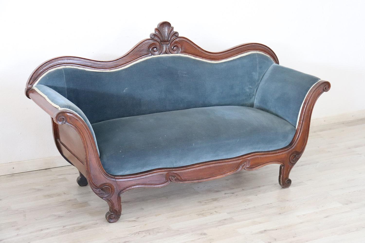Antique settee 1845s in full Louis Philippe era. The settee is made of solid beech wood hand carved. Refined velvet in blue color. Excellent antique good conditions of the wood, some signs of wear in the velvet. It is an adorable sofa due to its