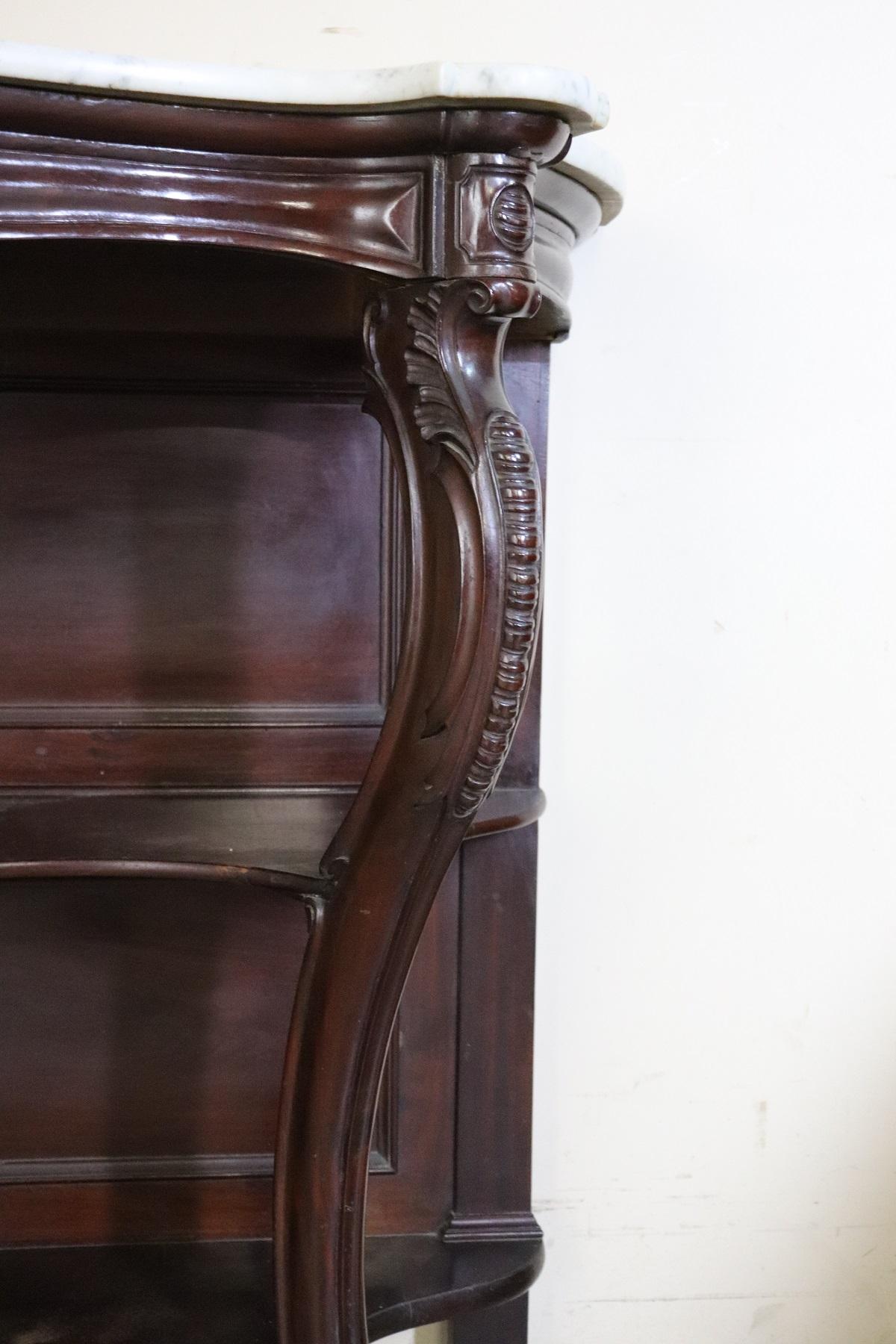 Italian antique console table, circa 1845. Characterized by precious mahogany with wood carving. Refined Genovese carving work performed by an important cabinet maker. Look at the front legs moved enriched with carved in the wood. The gray Carrara