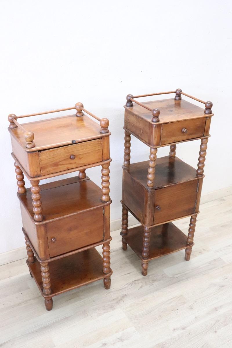 Lovely antique Italian pair of nightstands of the period Louis Philippe, 19th century in solid walnut wood. The nightstands very refined linear and elegant with on the front decorative turned columns. On the front one-drawer and one-door. Very
